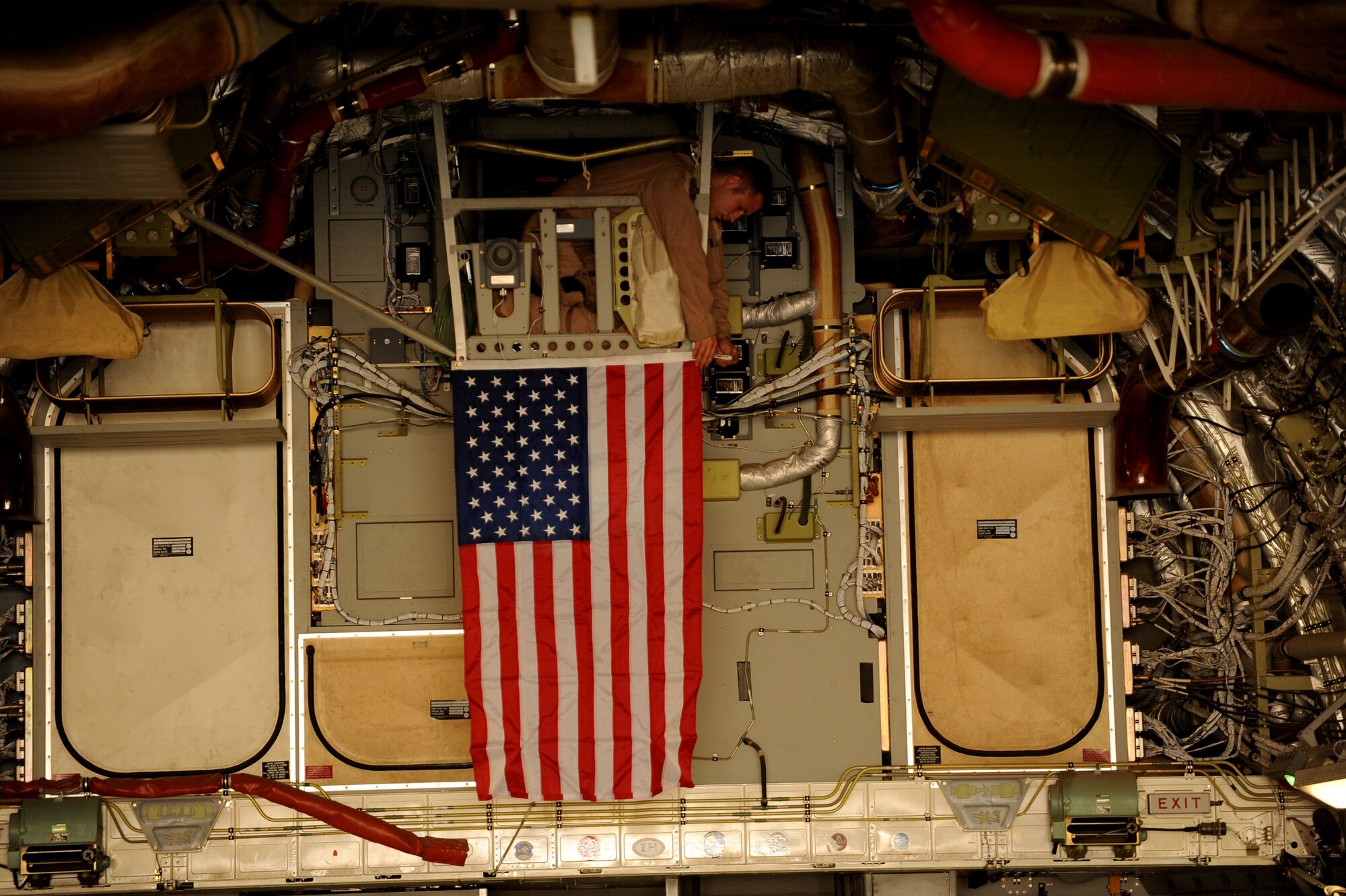 Staff Sgt. Derick Clements, a C-17 Globemaster III loadmaster assigned to 816nd Expeditionary Airlift Squadron in Southwest Asia, prepares the C-17 to transport human remains, April 20, 2010, at Camp Bastion, Afghanistan. ?We hang the flag and carry human remains home with the ultimate respect,? said Sergeant Clemons, deployed from Charleston AFB, S.C.  ?It is not a mission we enjoy doing at all, but we are honored when we get the chance to take patriots who paid the ultimate sacrifice back to their families. These people served their country with valor and it is a pleasure to part of an airlift operation that remembers and takes care of our fallen warriors.?  (U.S. Air Force photo/Staff Sgt. Manuel J. Martinez/released)