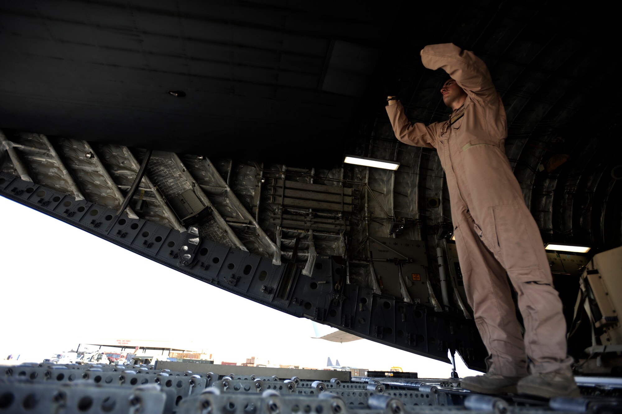 Senior Airman Kyle Curry, a C-17 Globemaster III loadmaster assigned to 732nd Expeditionary Airlift Squadron at Transit Center at Manas, guides an aerial porter assigned to 451st Expeditionary Logistics Readiness Squadron's Detachment 1, utilizing a forklift, April 20, 2010, at Camp Bastion, Afghanistan.  (U.S. Air Force photo/Staff Sgt. Manuel J. Martinez/released)
