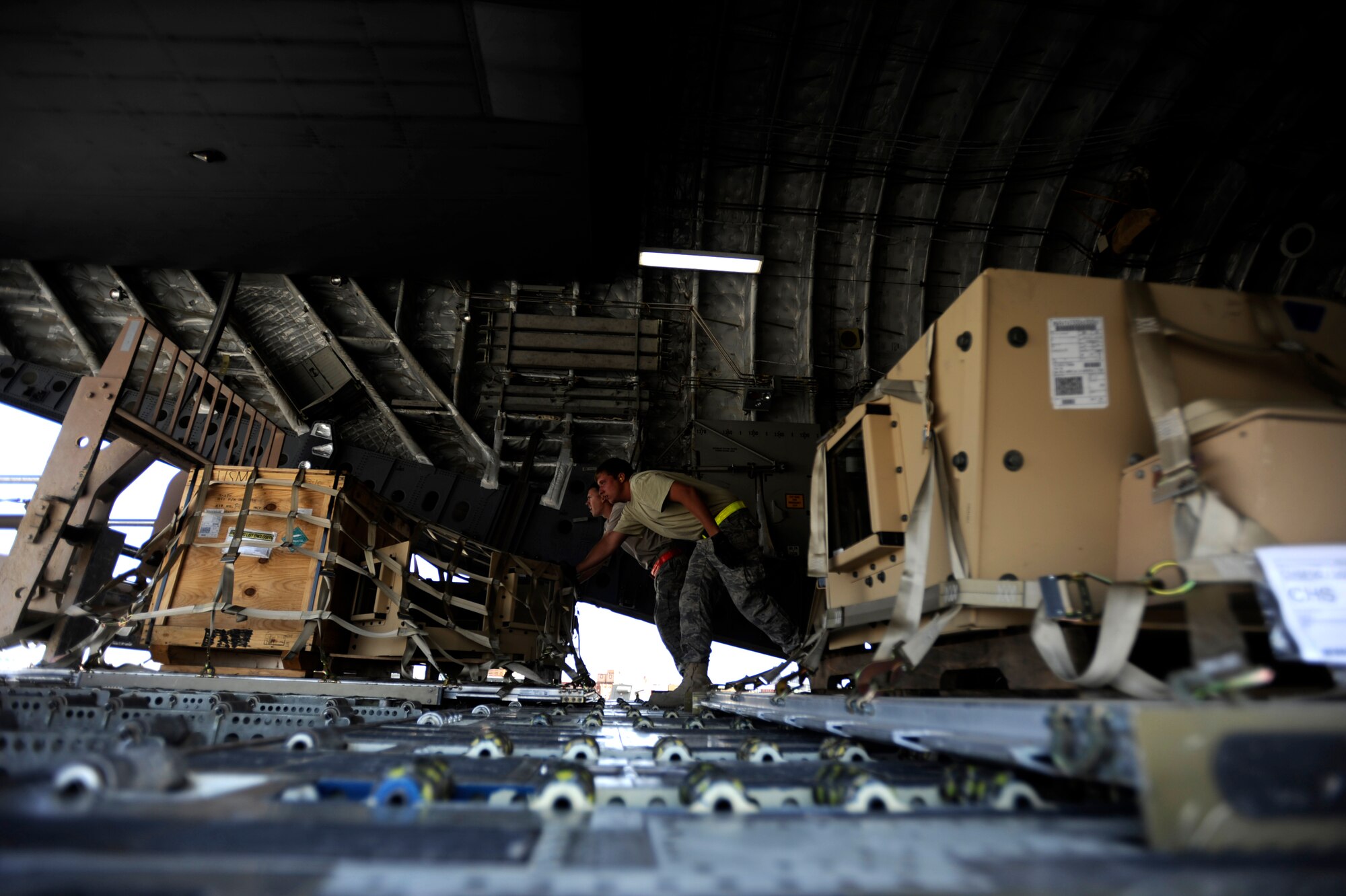 Aerial porters assigned to 451st Expeditionary Logistics Readiness Squadron's Detachment 1, push pallets onto a waiting forklift from a C-17 Globemaster III, April 20, 2010, at Camp Bastion, Afghanistan. (U.S. Air Force photo/Staff Sgt. Manuel J. Martinez/released)