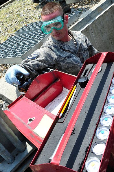 Staff Sgt. Jesse Venable, 51st Logistics Readiness Squadron, collects samples of JP-8 fuel following a delivery by train May 11. (U.S. Air Force photo/Staff Sgt. Eunique Stevens)