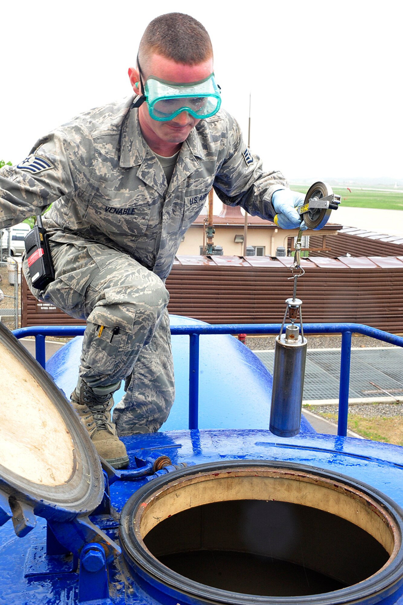 Staff Sgt. Jesse Venable, 51st Logostics Readiness Squadron, checks the quality of JP-8 fuel delivered by train May 11. (U.S. Air Force photo/Staff Sgt. Eunique Stevens)
