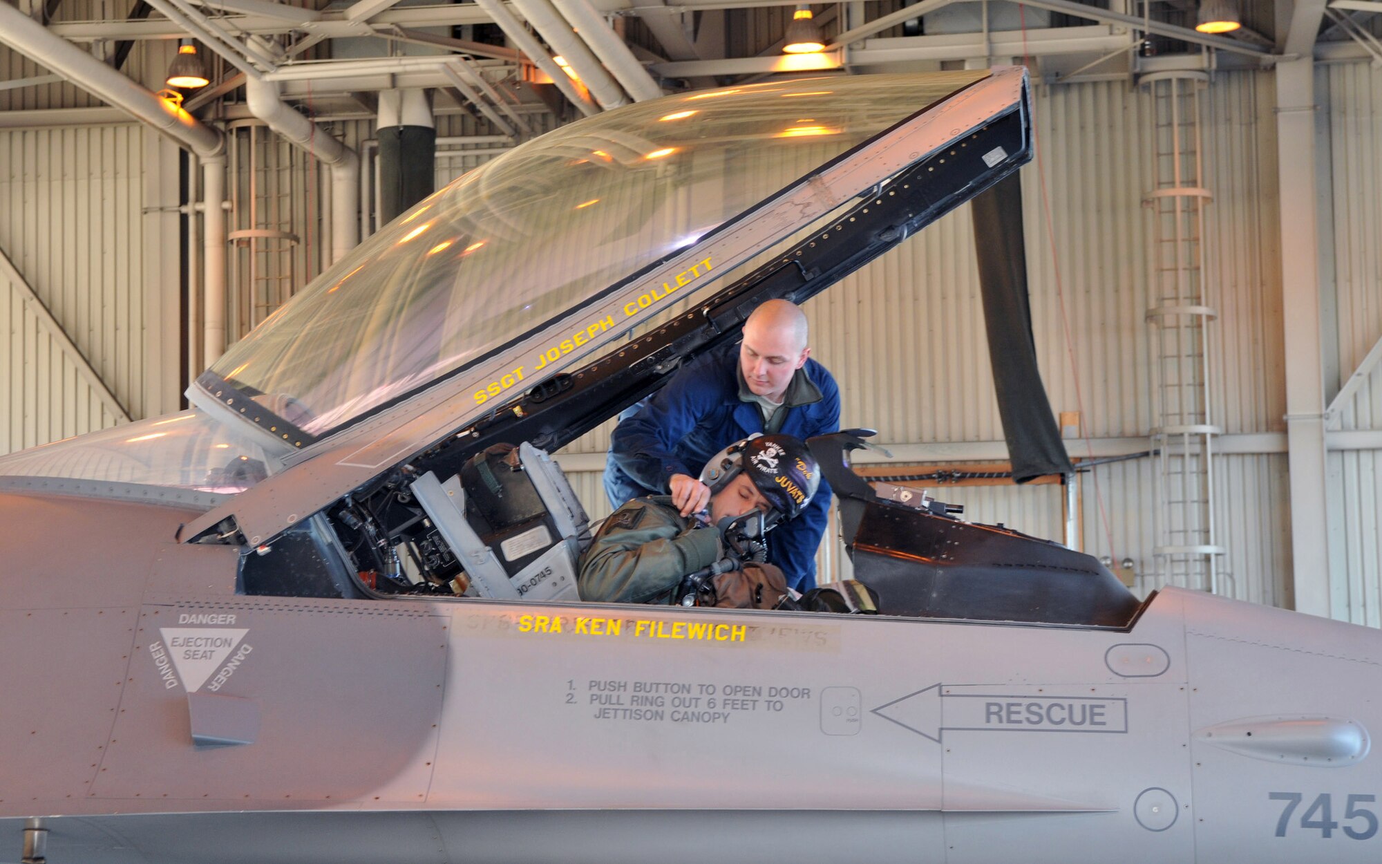 Senior Airman Ken Filewich, 8th Aircraft Maintenance Squadron, 80th Aircraft Maintenance Unit, crewchief, assists 1st Lt. Jondavid Hertzel, 80th Fighter Squadron pilot, before a mission at Red Flag-Alaska April 21. Both Airmen are deployed from the 8th Fighter Wing, Kunsan Air Base, Republic of Korea. (U.S. Air Force photo/Capt. Shannon Collins)