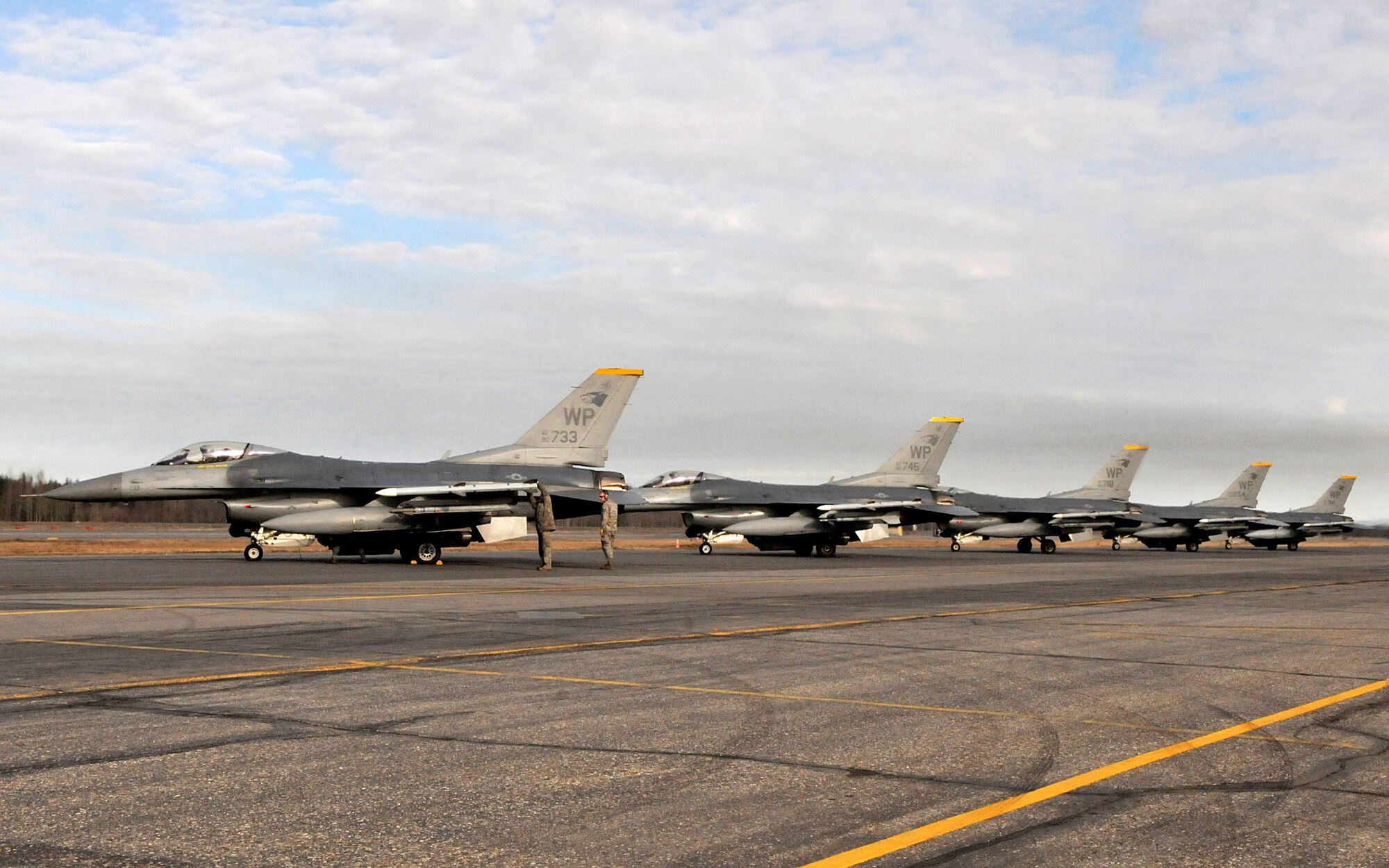 Senior Airman Sean Edmondson, a weapons load team member with the 8th Aircraft Maintenance Squadron, performs a final pre-flight inspection of the weapons on an F-16 Fighting Falcon, as crewchief Staff Sgt. Blake Bocinski, performs an overall inspection before the pilot takes off to complete a mission during Red Flag-Alaska April 28. The Airmen are deployed from the 8th Fighter Wing, Kunsan Air Base, Republic of Korea. Red Flag-Alaska is a field training exercise that provides joint offensive counter-air, interdiction, close air support, and large force employment training in a simulated combat environment. (U.S. Air Force photo/Capt. Shannon Collins)