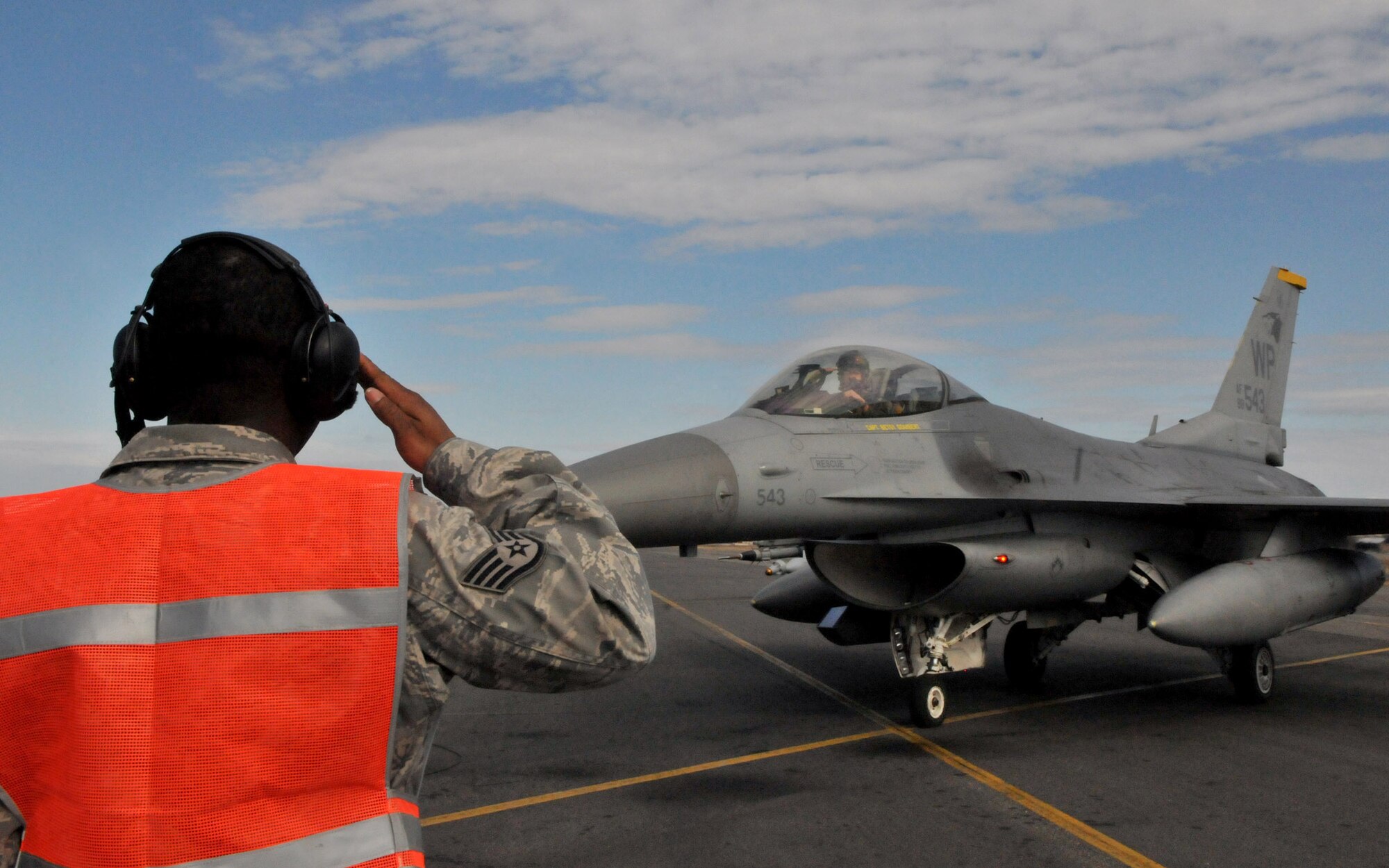 Staff Sgt. Nathaniel Seeney, a weapons load team chief with the 8th Aircraft Maintenance Squadron, renders a salute to an F-16 Fighting Falcon pilot after his team performed their final pre-flight inspection before the pilot takes off on a mission during Red Flag-Alaska April 28. Sergeant Seeney is deployed from the 8th Fighter Wing, Kunsan Air Base, Republic of Korea. Red Flag-Alaska is a field training exercise that provides joint offensive counter-air, interdiction, close air support, and large force employment training in a simulated combat environment. (U.S. Air Force photo/Capt. Shannon Collins)