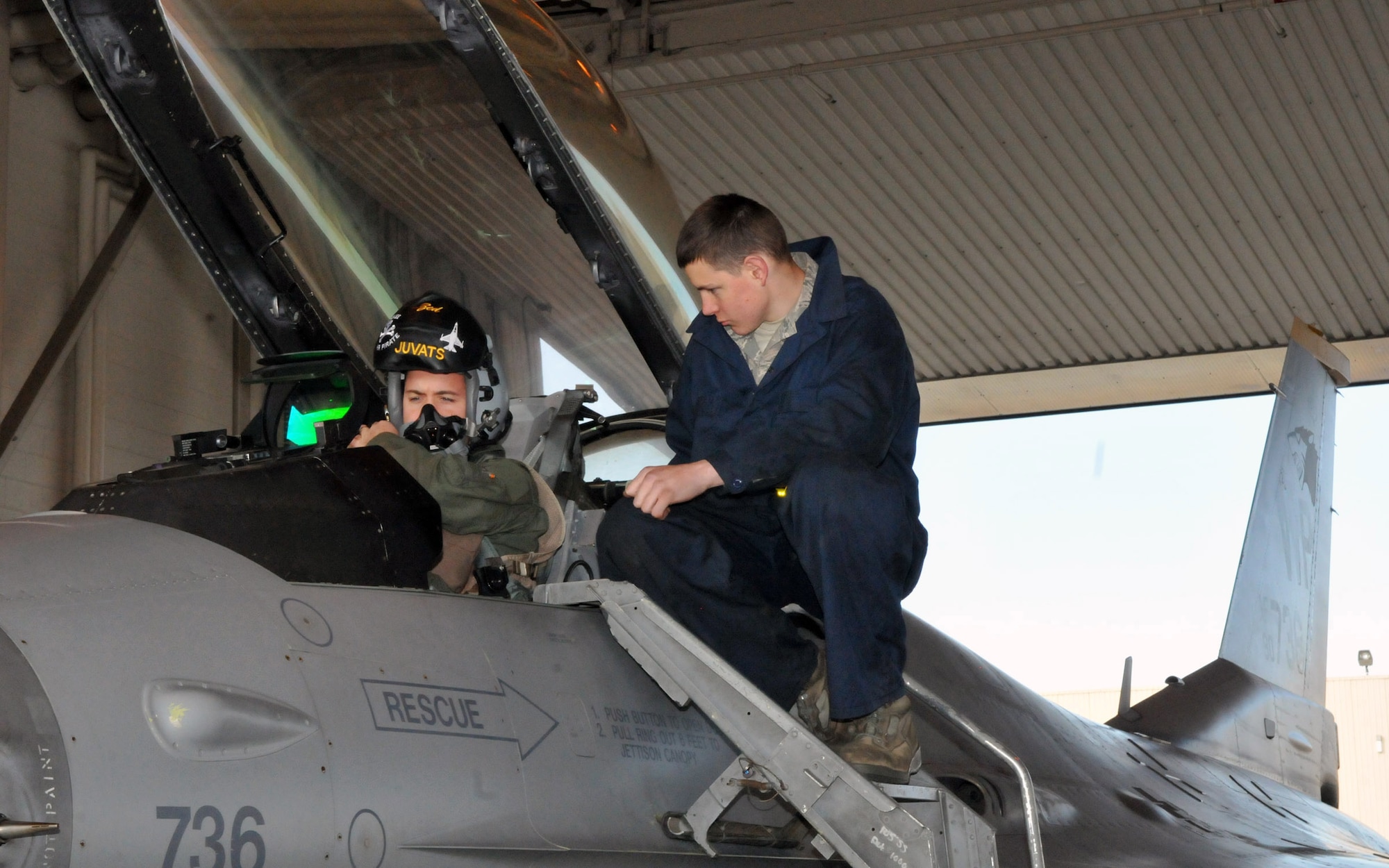 1st Lt. Matt Ott, an 80th Fighter Squadron pilot, buckles into an F-16 Fighting Falcon as Airman 1st Class Robert Scaplehorn, a crewchief with the 80th Aircraft Maintenance Unit, stands by, ready to assist or make adjustments before a mission during Red Flag-Alaska April 28. Lieutenant Ott and Airman Scaplehorn are deployed from the 8th Fighter Wing, Kunsan Air Base, Republic of Korea. Red Flag-Alaska is a field training exercise that provides joint offensive counter-air, interdiction, close air support, and large force employment training in a simulated combat environment. (U.S. Air Force photo/Capt. Shannon Collins)