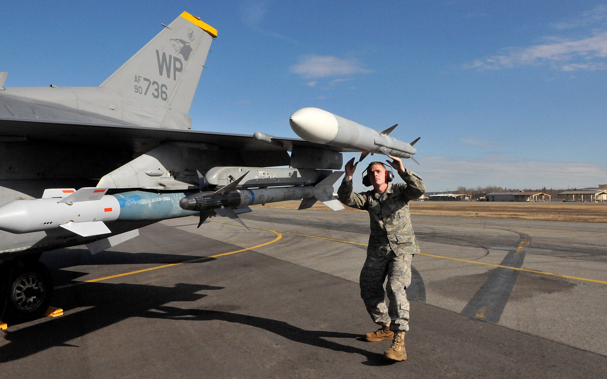 Senior Airman Sean Edmondson, a weapons load team member with the 8th Aircraft Maintenance Squadron, performs a final pre-flight inspection of an F-16 Fighting Falcon before the pilot takes off to complete a mission during Red Flag-Alaska April 28. Airman Edmondson is deployed from the 8th Fighter Wing, Kunsan Air Base, Republic of Korea. Red Flag-Alaska is a field training exercise that provides joint offensive counter-air, interdiction, close air support, and large force employment training in a simulated combat environment. (U.S. Air Force photo/Capt. Shannon Collins)