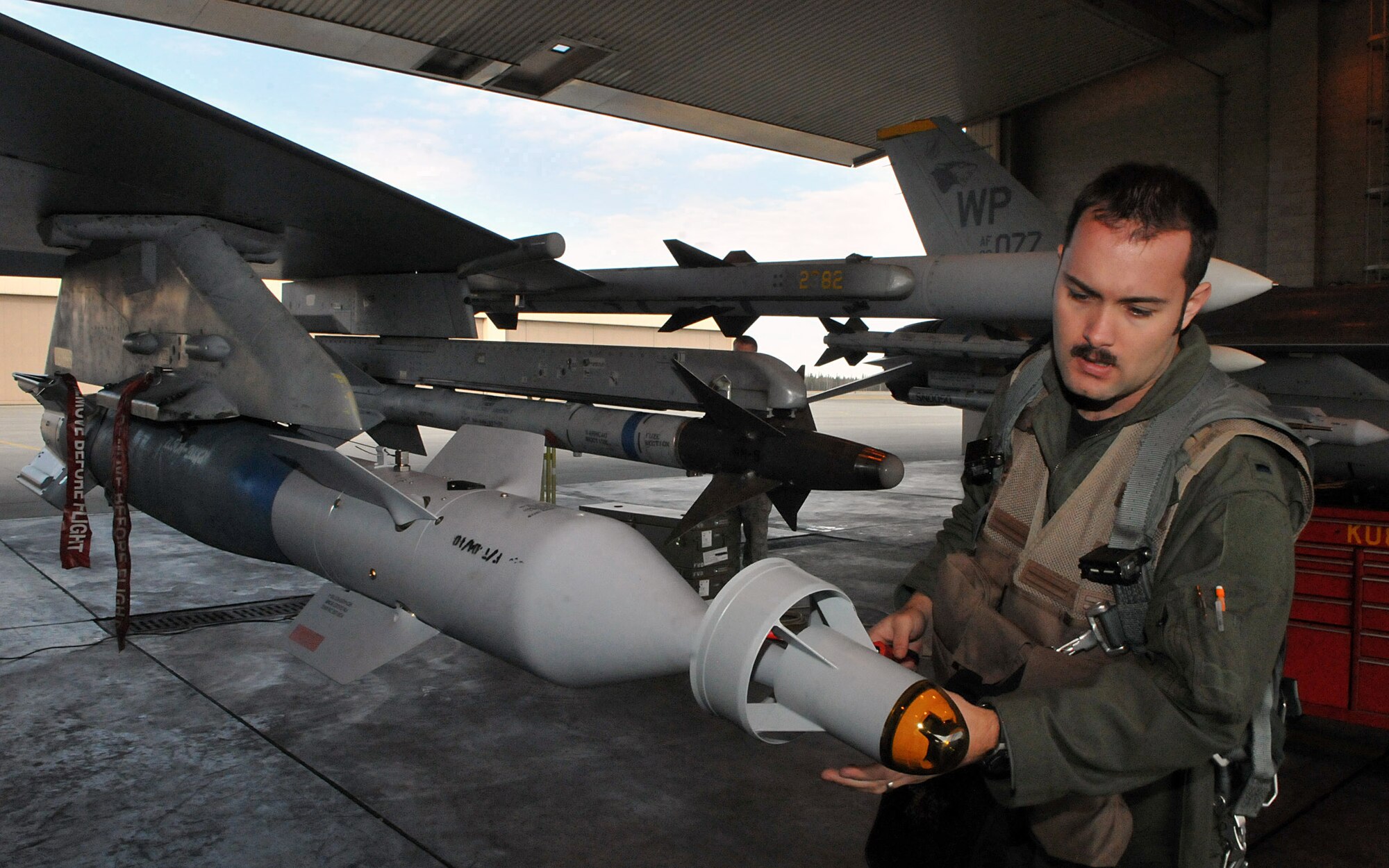 1st Lt. Matt Ott, an 80th Fighter Squadron F-16 Fighting Falcon pilot, makes a few quick adjustments before a mission during Red Flag-Alaska April 28. Lieutenant Ott is deployed from the 8th Fighter Wing, Kunsan Air Base, Republic of Korea. Red Flag-Alaska is a field training exercise that provides joint offensive counter-air, interdiction, close air support, and large force employment training in a simulated combat environment. (U.S. Air Force photo/Capt. Shannon Collins)