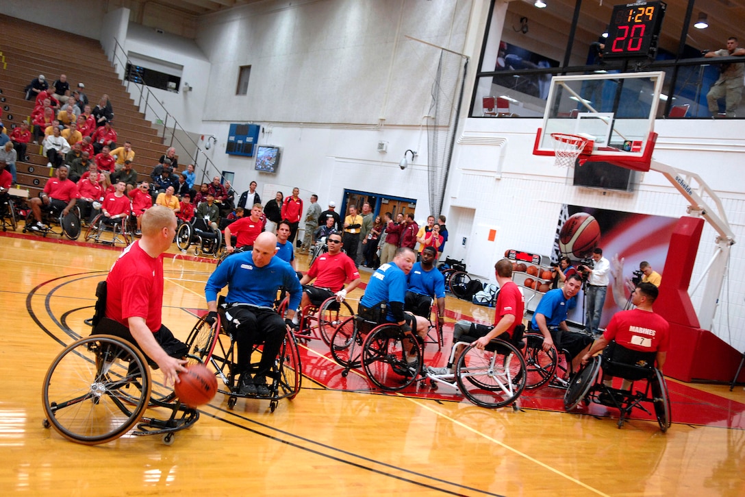 Retired U.S. Marine Corps Cpl. Travis Greene looks to make his move during a wheelchair basketball game at the U.S. Olympic Training Center in Colorado Springs, Colo., May 11, 2010. The Marines routed the U.S. Air Force 68-13 in the preliminary round of the inaugural Warrior Games' wheelchair basketball pool play.