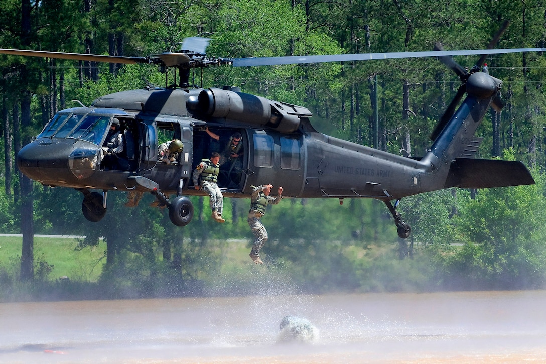 U.S. Army Staff Sgt. Kyle Skaggs and Michael Ayotte conduct an air assault over water as part of the helo cast event during the 2010 Best Ranger Competition, Camp Darby, Fort Benning, Ga., May 09, 2010. Skaggs and Ayotte are assigned to the 6th Ranger Training Battalion. Teams were required to construct a poncho raft and use it to get their gear to the shores to complete the event.