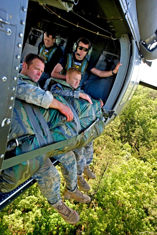 U.S. Army Staff Sgts. Warren Cash and Danny Shedd await their arrival to Victory Pond to complete the Helo Cast event during the 2010 Best Ranger Competition, Camp Darby, Fort Benning, Ga., May 09, 2010. Teams were dropped into the pond and were required to swim to shore.
