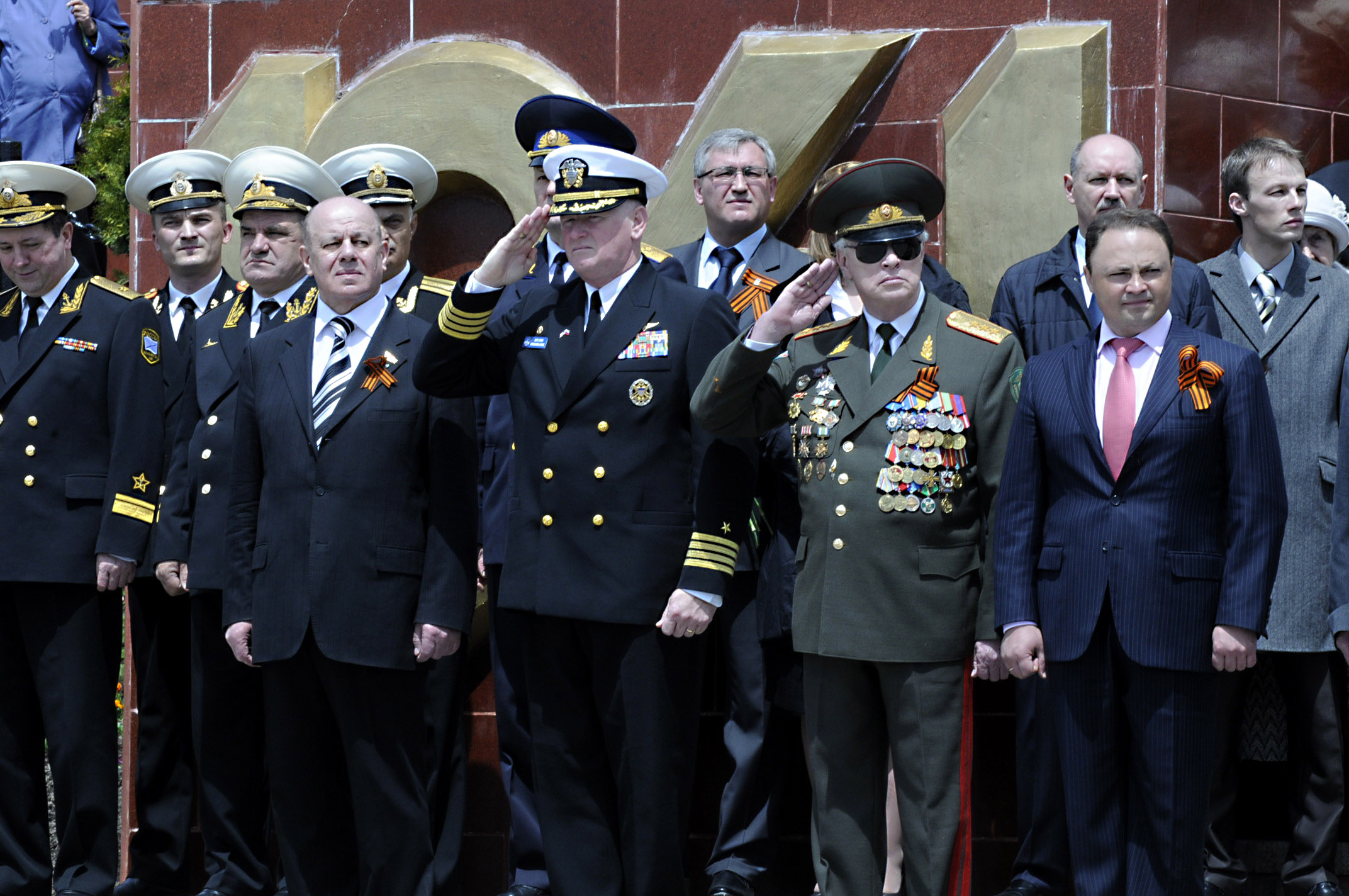 U.S. Navy Capt. Rudy Lupton, center, commanding officer of the U.S. 7th