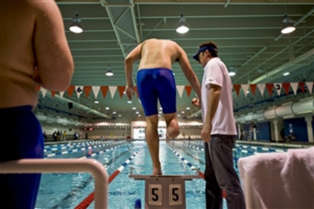 Air Force 2nd Lt. Ryan McGuire prepares to dive off the starting block during swim practice at the Olympic Training Center in Colorado Springs, Colo., May 11, 2010. McGuire is a below-the-knee-amputee competing in the inaugural Warrior Games through May 14.