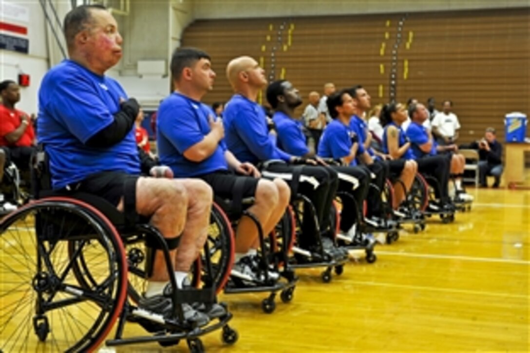 Members of Team Air Force raise their right hands above their hearts during the national anthem before playing a game of basketball against the Marines May 11, 2010, during the inaugural Warrior Games at the Olympic Training Center in Colorado Springs, Colo., May 11, 2010. The competition runs through May 14.