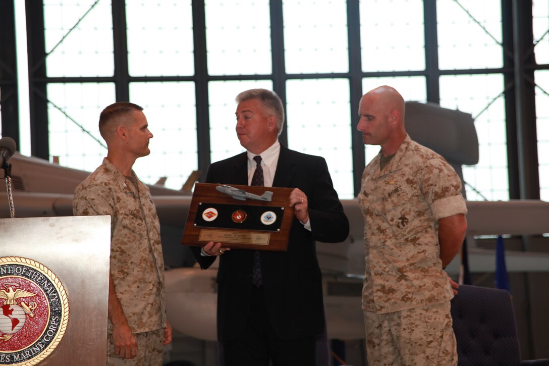 Steve Hogan, Northrop Grumman’s vice president of information operations and electronic attack, presents a plaque to Col. Russell A. Sanborn, the commanding officer of Marine Aircraft Group 14, and Lt. Col. David A Suggs, the commanding officer for Marine Tactical Electronic Warfare Squadron 4, during a ceremony to commemorate the addition of the EA-6B Prowler Improved Capability III, May 13. The ICAP III provides the EA-6B Prowler with more powerful and additional tools to aid the war fighters, according to the Northrop Grumman Web site.