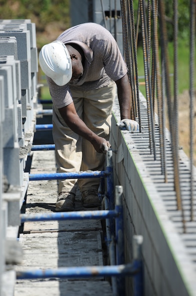 MOODY AIR FORCE BASE, Ga. -- Frank Flucas, contract worker, uses a trowel to smooth out mortar between cinder blocks during construction on the Combat Arms Training and Maintenance firing range here May 10. Construction on the CATM site began April 5 and is scheduled to be completed in approximately six to eight months. (U.S. Air Force photo by Airman 1st Class Benjamin Wiseman/ RELEASED)