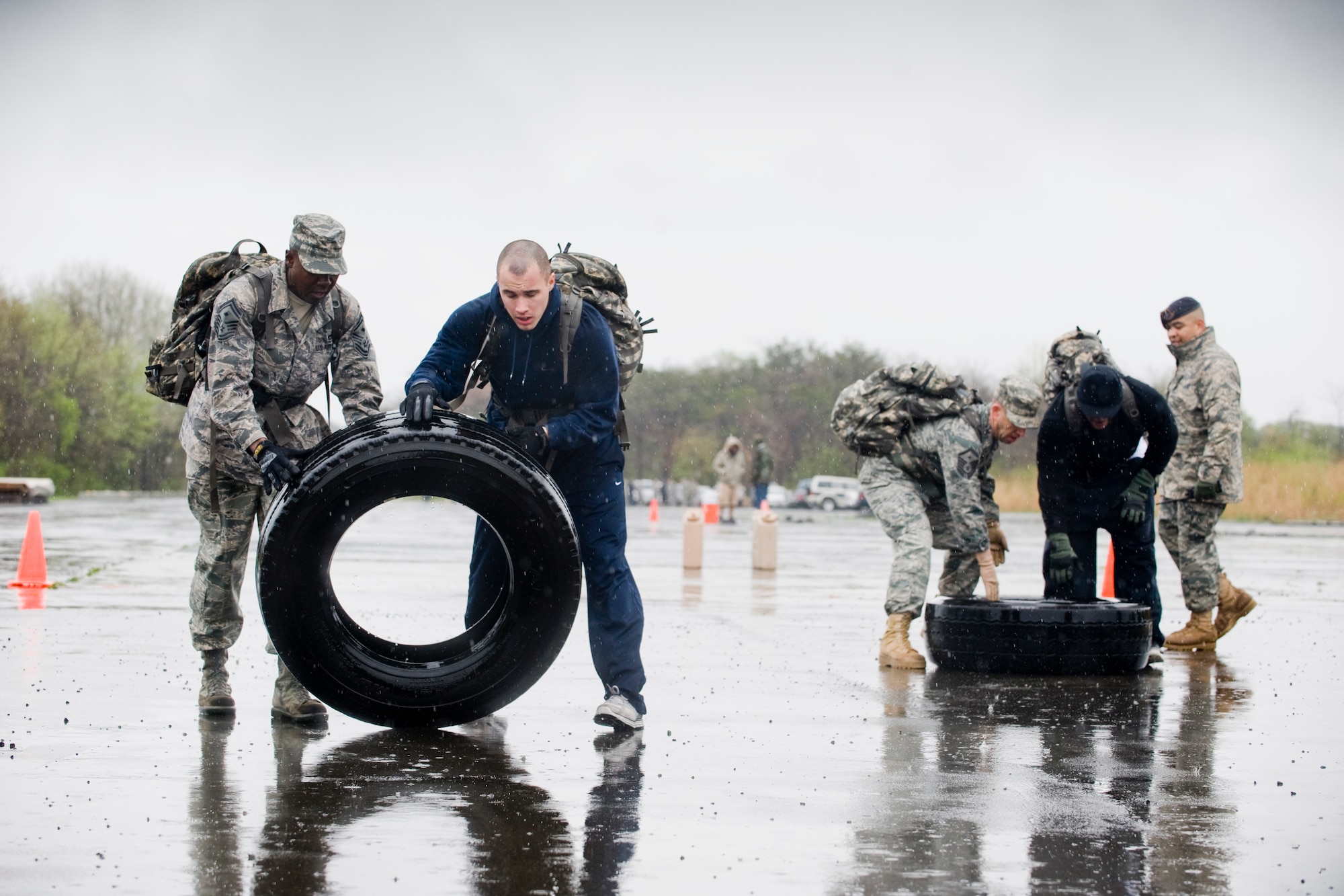 MISAWA AIR BASE, Japan -- A team consisting of Senior Master Sgt. Ross, Airman 1st Class Patrick Cahill, Master Sgt. Jason Beardsley and Damon Eppenger-Campbell work together to flip tires during an Air-Base Defense Challenge May 12 at Security Hill. The competition required teamwork with events such as a humvee push, water canister relay, litter carry and memory test. (U.S. Air Force photo/Senior Airman Jamal D. Sutter)