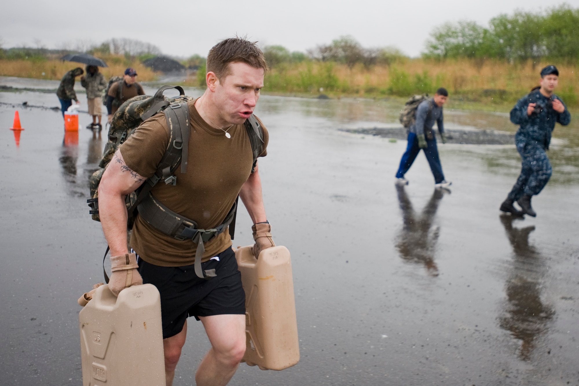 MISAWA AIR BASE, Japan -- Petty Officer 2nd Class John Goodson, Navy Information Operations Command cryptological technician, races against the clock during an Air-Base Defense Challenge May 12 at Security Hill. The challenge was a timed competition part of National Police Week. It physically tested its competitors while promoting stronger relationships between the 35th Security Forces Squadron and NIOC. (U.S. Air Force photo/Senior Airman Jamal D. Sutter)