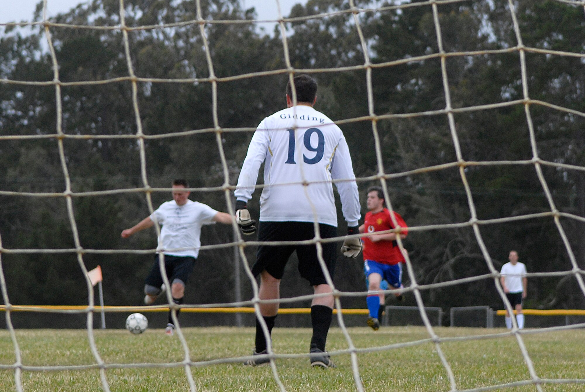 VANDENBERG AIR FORCE BASE, Calif. -- Thomas Giddings III, a 30th Space Communications Squadron team member, defends the goal against Will Davis, a 30th Launch Group team member, during an intramural soccer game at the base field here Wednesday, May 12, 2010.  The 30th Launch Group swept the game 9-0.  (U.S. Air Force photo/Senior Airman Andrew Satran) 

 

 
