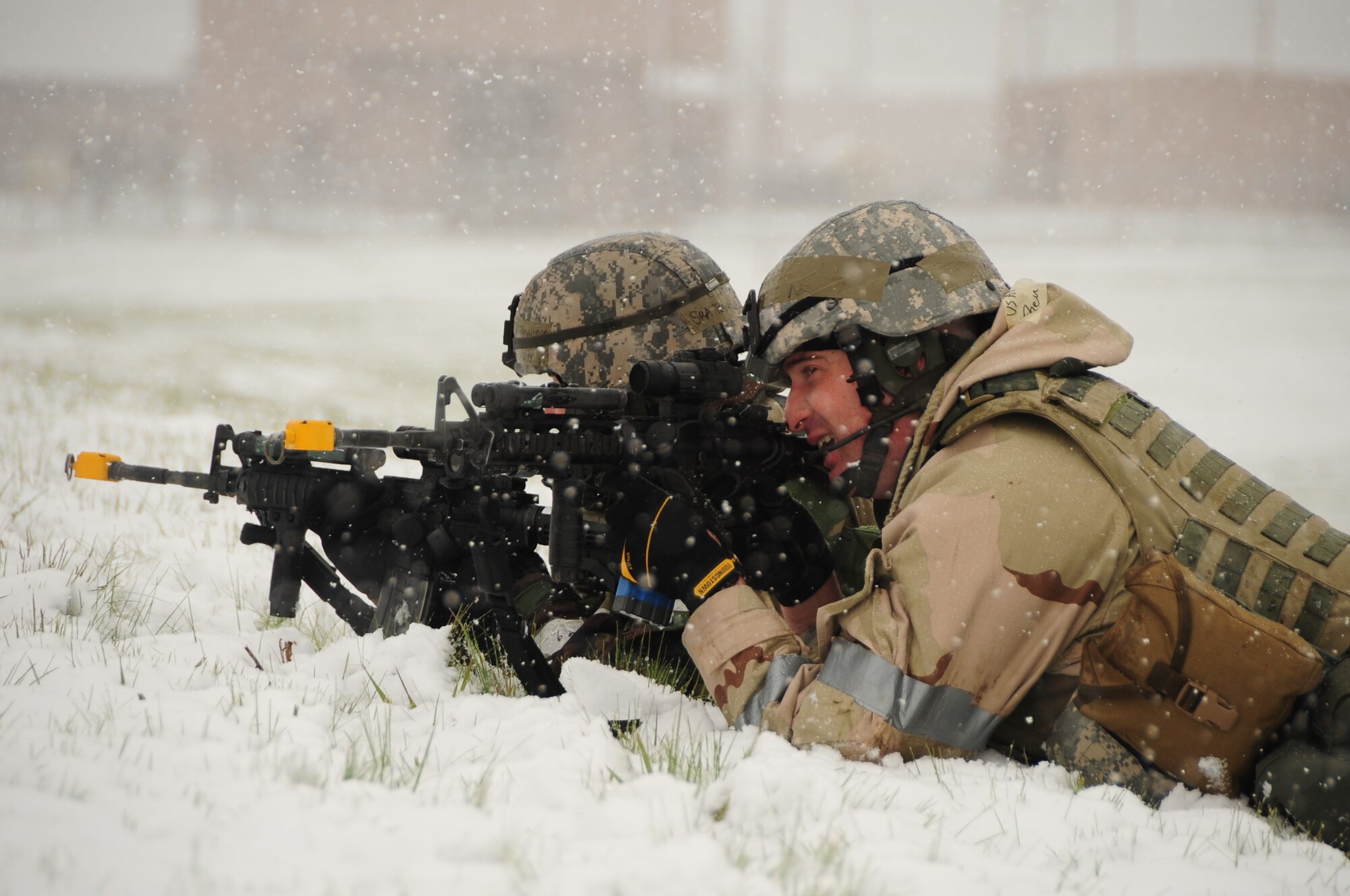 ELLSWORTH AIR FORCE BASE, S.D. – (Left to right) Senior Airman Kristi Terwilliger and Staff Sgt. Benjamin Pieta, 28th Security Forces Squadron patrolmen, take aim in the prone position during a Phase II Operational Readiness Exercise, May 12.  The Phase II ORE tested Airmen across the base on their ability to operate in a deployed environment. (U.S. Air Force photo/Airman 1st Class Anthony Sanchelli)