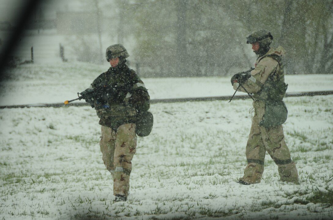 ELLSWORTH AIR FORCE BASE, S.D. – (Front to back) Staff Sgt. Benjamin Pieta and Senior Airman Kristi Terwilliger, 28th Security Forces Squadron patrolmen, patrol their area during a Phase II Operational Readiness Exercise, May 12.  The Phase II ORE tested Airmen across the base on their ability to operate in a deployed environment. (U.S. Air Force photo/Airman 1st Class Anthony Sanchelli) 