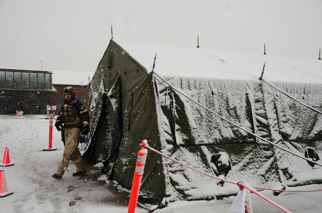 ELLSWORTH AIR FORCE BASE, S.D. – Senior Airman Jeremy Ross, 28th Security Forces Squadron patrolman, leaves a covered tent to patrol the area during a Phase II Operational Readiness Exercise, May 12.  Airmen continued to perform during the Phase II ORE, Which tested deployed combat readiness, regardless of weather conditions. (U.S. Air Force photo/Airman 1st Class Anthony Sanchelli)