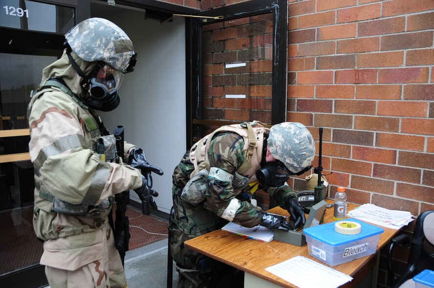 ELLSWORTH AIR FORCE BASE, S.D. -- (Left) Senior Airman David Brock, 28th Security Forces Squadron Airman, checks identification on Master Sgt. Katherine Proffit, 28 SFS Airman, during a Phase II Operational Readiness Exercise while in mission oriented protective posture gear, May 11.  The exercise is a simulated deployment which tests Airmen on their skills and abilities while under stressful conditions. (U.S. Air Force photo/Airman 1st Class Anthony Sanchelli)