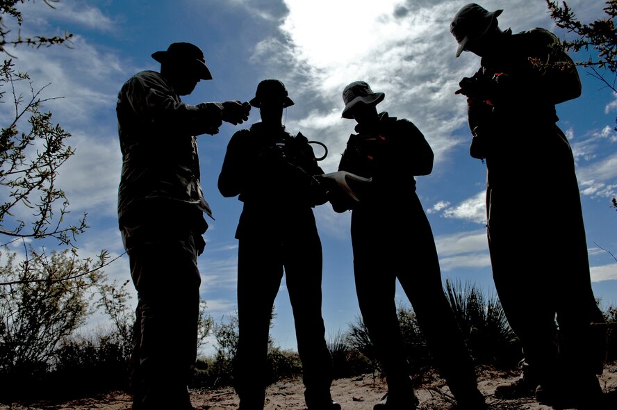 A survival, evasion, resistance and escape specialist demonstrates how to use a Global Positioning System to Airmen with the 7th Fighter Squadron, May 5, 2010, during a SERE refresher training course at Holloman Air Force Base, N.M.  Pilots and aircrew members are required to demonstrate competency in SERE techniques on a recurring basis. (U.S. Air Force photo/Airman 1st Class Joshua Turner)


