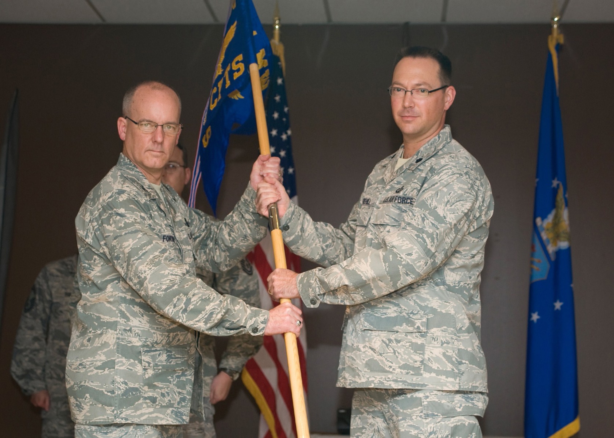Col. Michael Fortney, 341st Missile Wing commander, presents the 341st Comptroller Squadron guidon to Lt. Col. Trevor Whitehill, 341st CPTS commander, at the activation ceremony May 7. The 341st CPTS activation under the 341st MW resulted after the deactivation of the 341st Comptroller Contracting Squadron. (U.S. Air Force photo/Beau Wade)