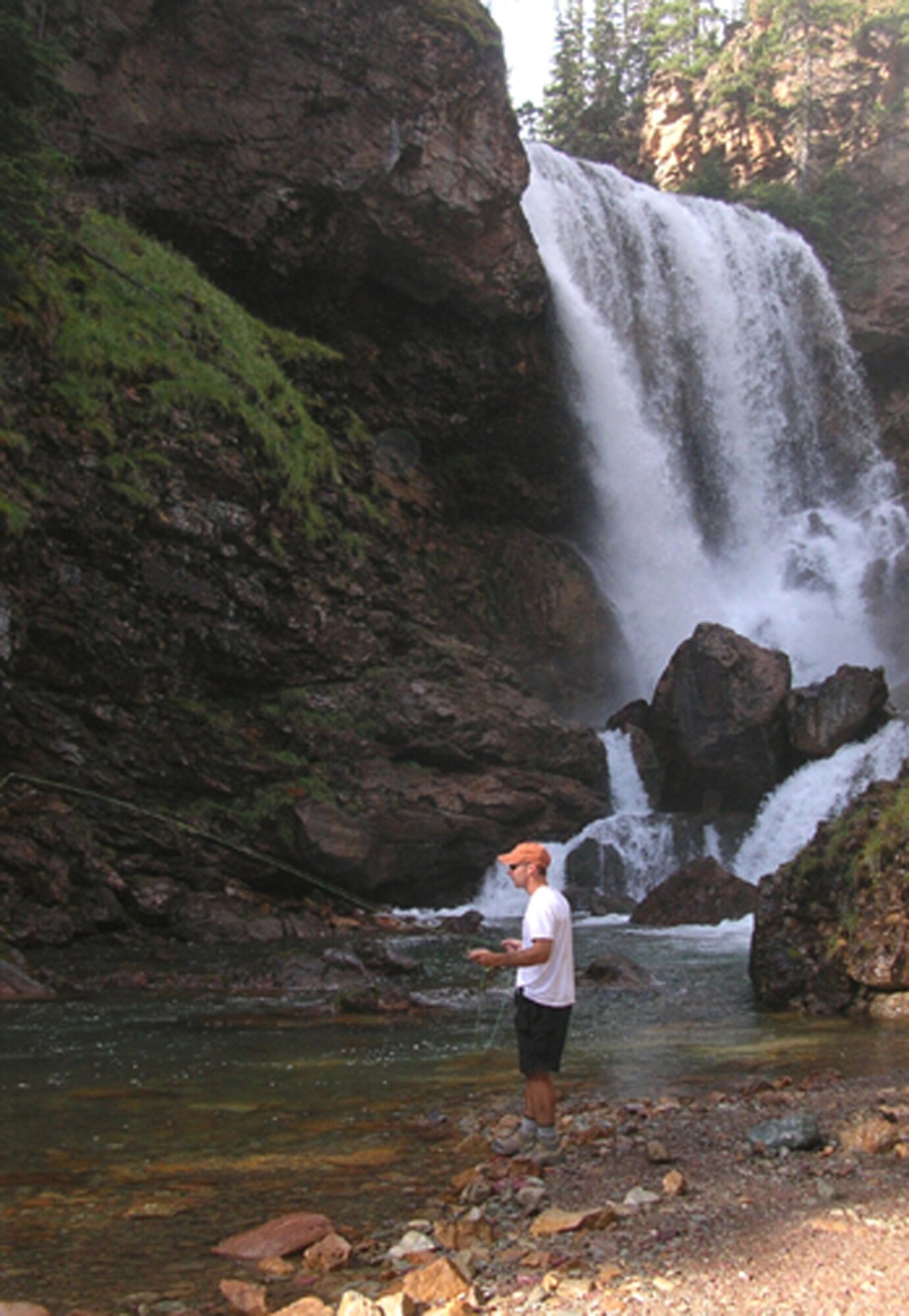 Tech. Sgt. Joseph Gandolfi, 341st Missile Wing Plans and Programs exercise evaluation team specialist, enjoys fishing at Dawn Mist Falls in Glacier National Park on one of the many Outdoor Recreation trips offered to the Park each year. (U.S. Air Force courtesy photo)