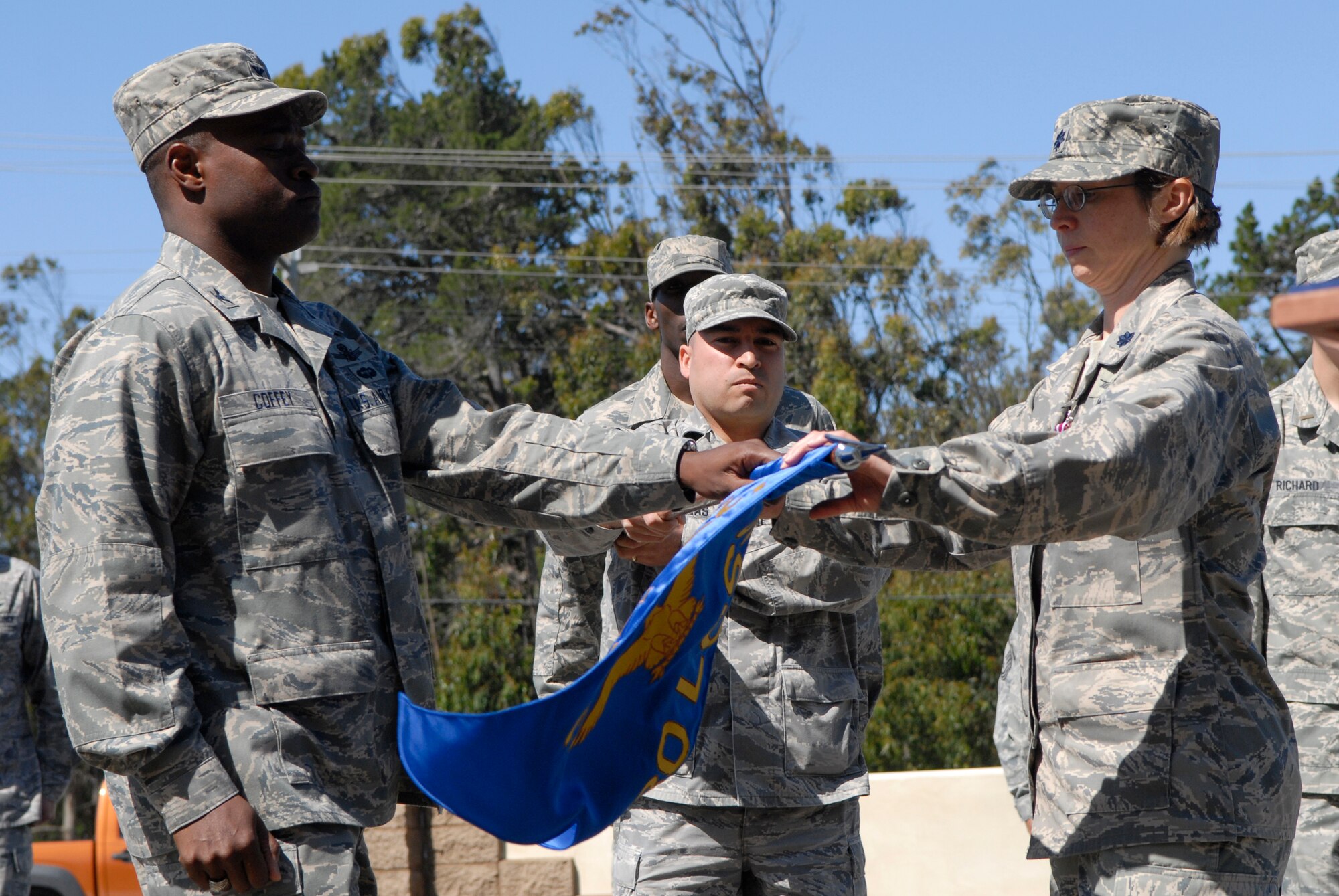 VANDENBERG AIR FORCE BASE, Calif. -- Col. Lavanson Coffey III, the 30th Launch Group commander, and Lt. Col. Elana Oberg, the 30th Launch Support Squadron commander, prepare the guidon to be cased during the 30th LCSS inactivation ceremony in front of the 30th LCG here Wednesday, May 12, 2010.  For the last five years the 30th LCSS has been responsible for the 30th LCG's payload processing and facility management. (U.S. Air Force photo/Senior Airman Andrew Satran) 