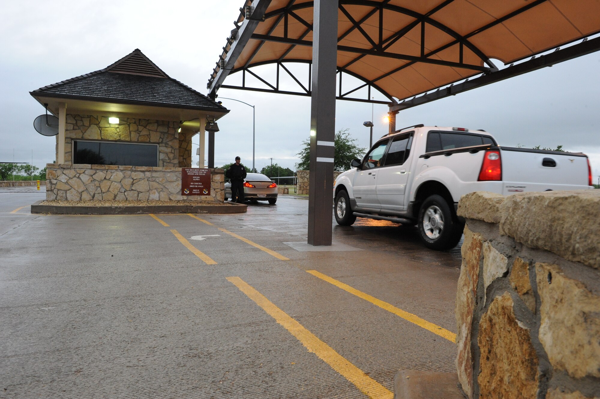 DYESS AIR FORCE BASE, Texas—Adam Keidl Jr., U.S. Protect employee, stands guard May 13 at the front gate here. The mission to keep Dyess safe does not stop because of weather. Employees from the U.S. Protect agency work with the 7th Security Forces Squadron securing the base 24/7 through rain, snow, heat and all kinds of weather. (U.S Air Force photo/Airman 1st Class Shannon Hall)