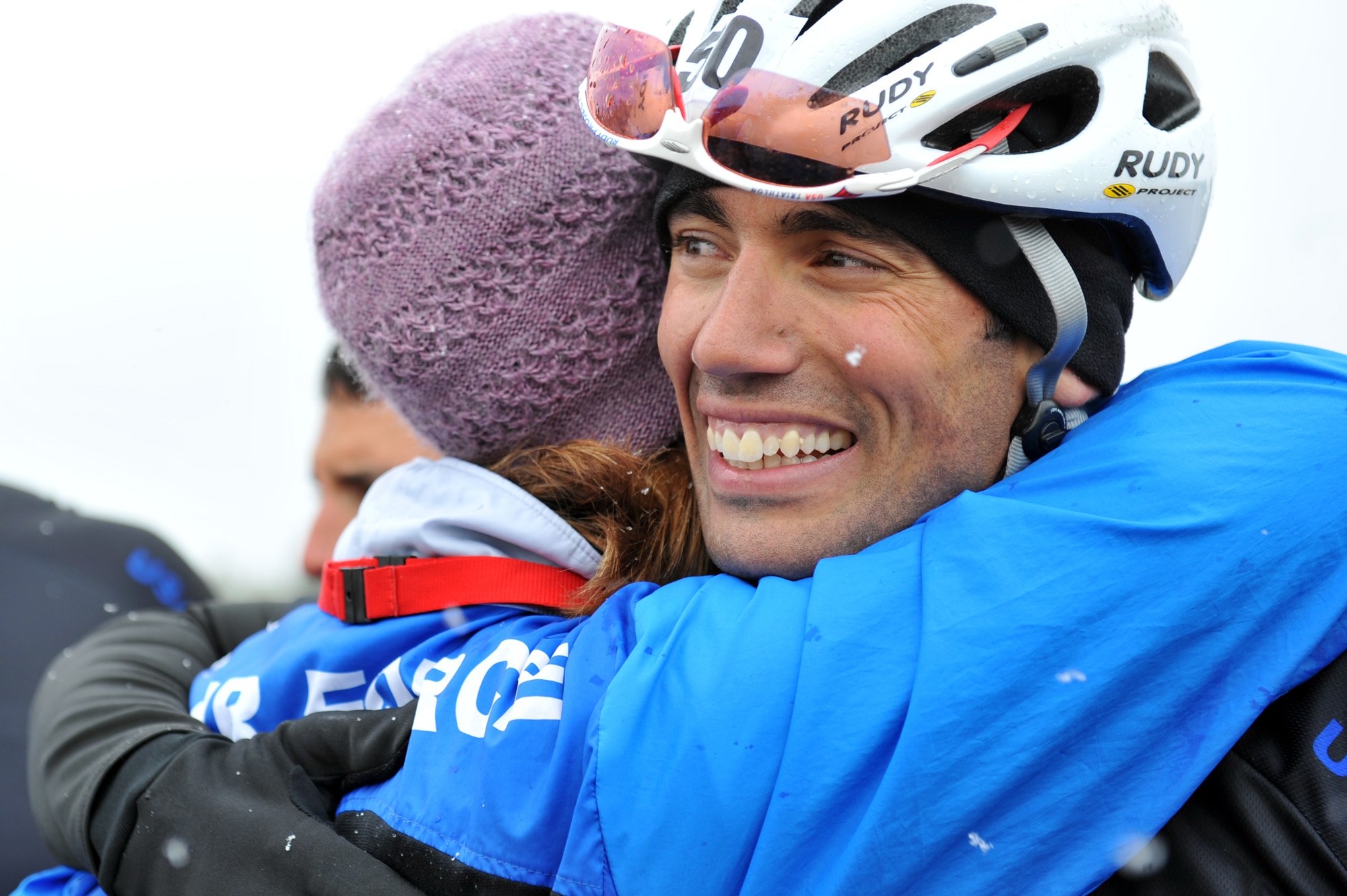 Adam Tanverdi receives a hug from Air Force head coach Cami Stock after finishing up in fourth place in the 20-kilometer upright bike race for the inaugural Warrior Games May 13, 2010, at the U.S. Air Force Academy in Colorado Springs, Colo.  Tanverdi is one of some 200 disabled veterans participating in the Paralympic-style competition May 10 through 14. (U.S. Air Force photo/Staff Sgt. Desiree N. Palacios)