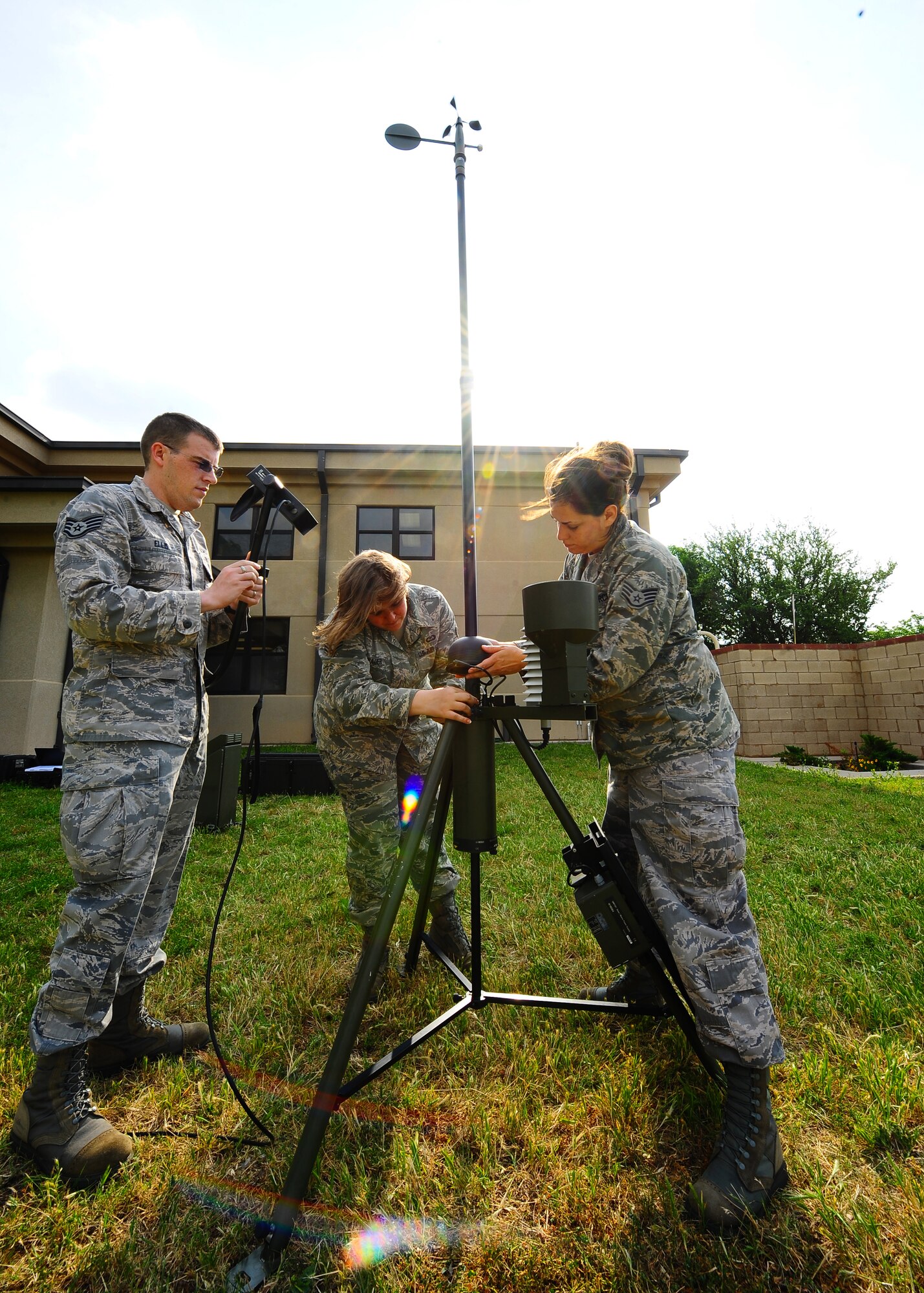 DYESS AIR FORCE BASE, Texas – Staff Sgt. James Ellis (center), Senior Airman Ann Winters (right) and Senior Airman Sara Wauer (left), 7th Operations Support Squadron weather forecasters, forecast the weather using a Tactical Meteorological Observing System (TMQ-53) near the flighline May 12 for upcoming storms here. This instrument detects wind direction, temperature, relative humidity, lightning, rain conditions, cloud depth and visibility. It also provides pilots weather patterns to help land aircraft in deployed locations. (U.S. Air Force photo/Senior Airman Stephen Reyes)