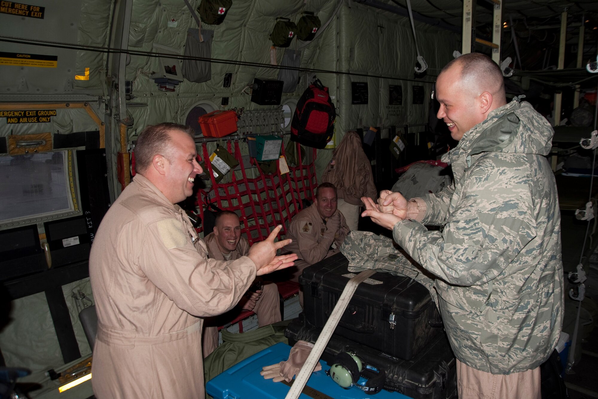 In the cargo hold of a 133rd Airlift Wing Minnesota Air National Guard C-130 Hercules two Loadmasters play a game of Rock, Paper, Scissors to decide who will brave the wind and rain to launch the C-130 13 May, 2010.  The aircraft and Airmen of the 133rd are deploying to Southwest Asia is support of Operation Enduring Freedom. The loadmaster performs the calculations and plans cargo and passenger placement to keep the aircraft within permissible center of gravity limits throughout the flight. Loadmasters ensure cargo is placed on the aircraft in such a way as to prevent overloading sensitive sections of the airframe and cargo floor. U.S. Air Force photo by Tech. Sgt. Erik Gudmundson(released)