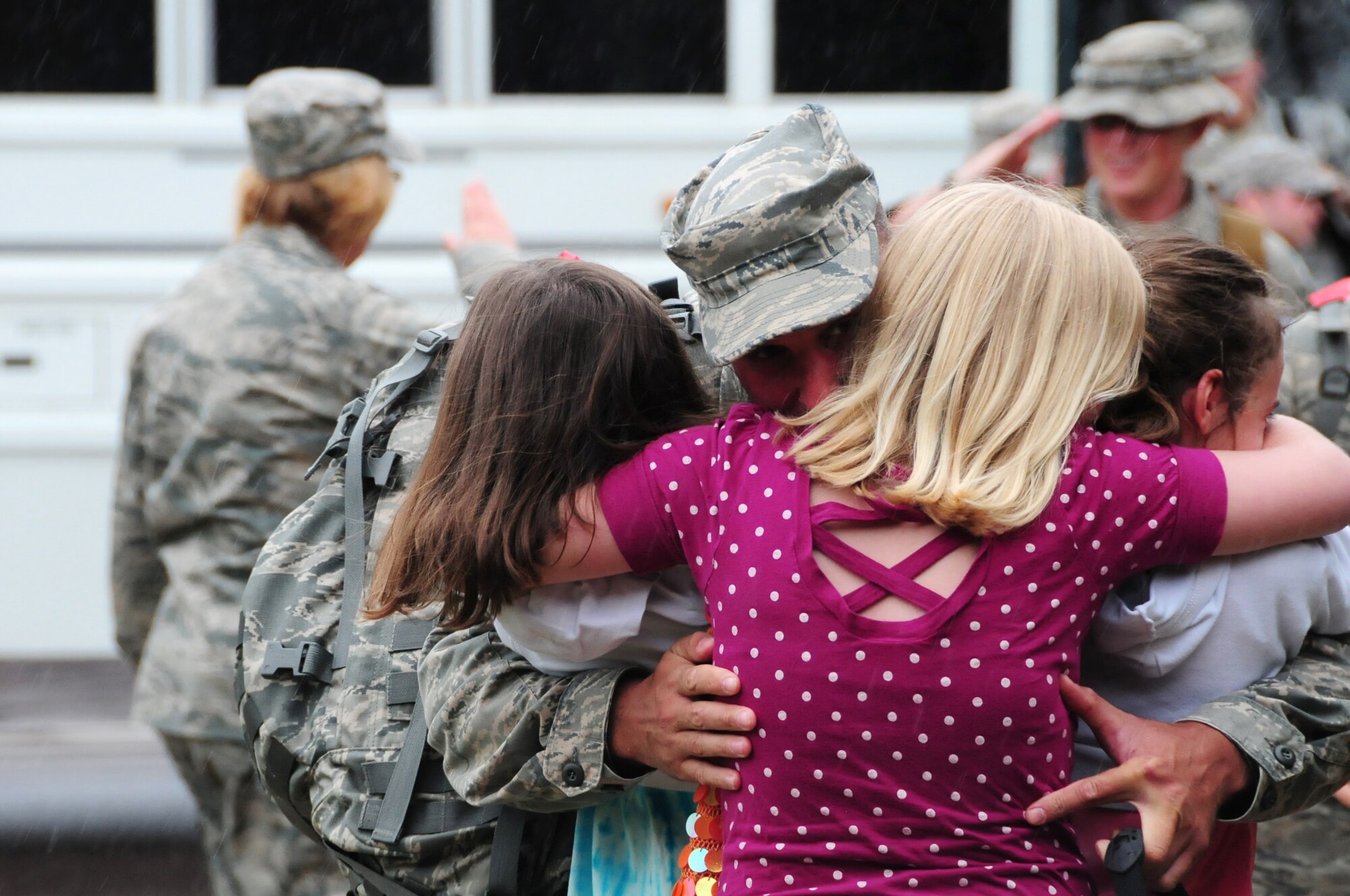 U.S. Air Force Senior Master Sgt. James Picconatto, 148th Fighter Wing Security Forces, embraces his three daughters as he arrives home at the Duluth, Minn., based Air National Guard base May 13, 2010. Approximately 35 Air National Guard members of the 148th Fighter Wing Security Forces Squadron returned to Duluth, Minn., after a 6-month deployment in southwest Asia. (U.S. Air Force photo by Master Sgt. Jason W. Rolfe/Released)
