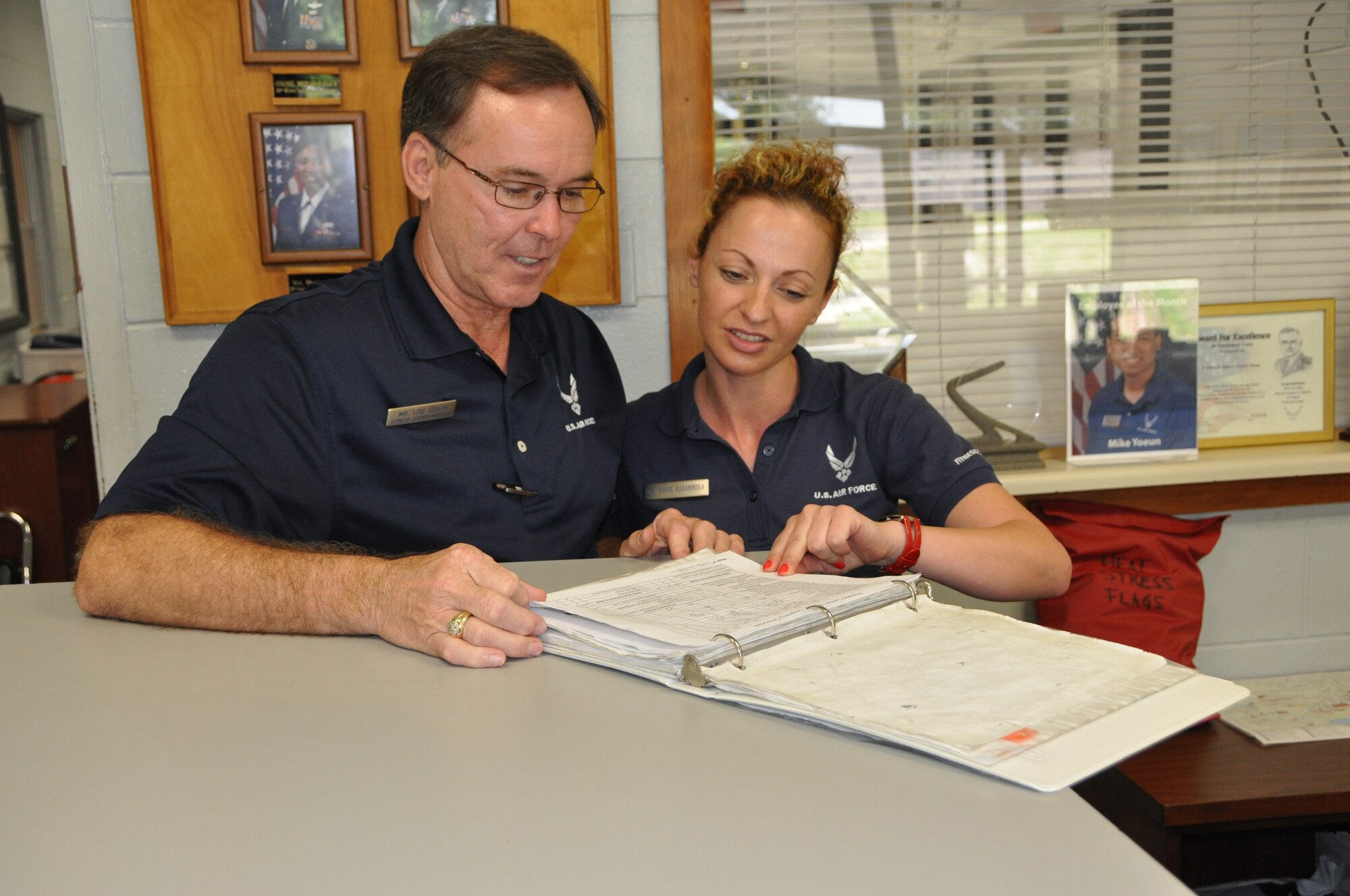Lou South, 325th Force Support Squadron fitness center director, views a checklist with Vivian Karanikola, 325th FSS recreation assistant, in the current gym May 13.  (U.S. Air Force photo by SrA Anthony J. Hyatt)