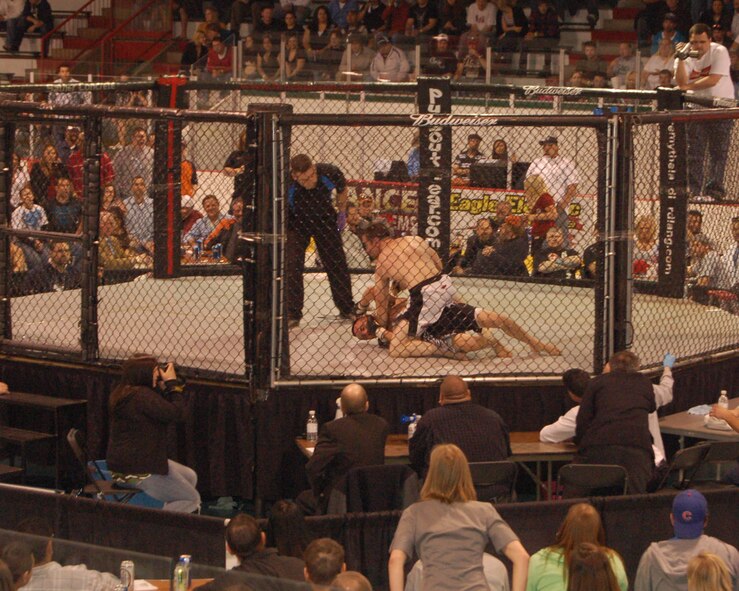 Staff Sgt. David Helmbrecht, 319th Security Forces Squadron Military Working Dog trainer, wrestles his opponent into submission May 8 at the East Grand Forks Civic Center during his first professional Mixed Martial Arts fight. Sergeant Helmbrecht won the fight in 2 minutes and 26 seconds. (U. S. Air Force photo by Airman 1st Class Rachel Martinez)