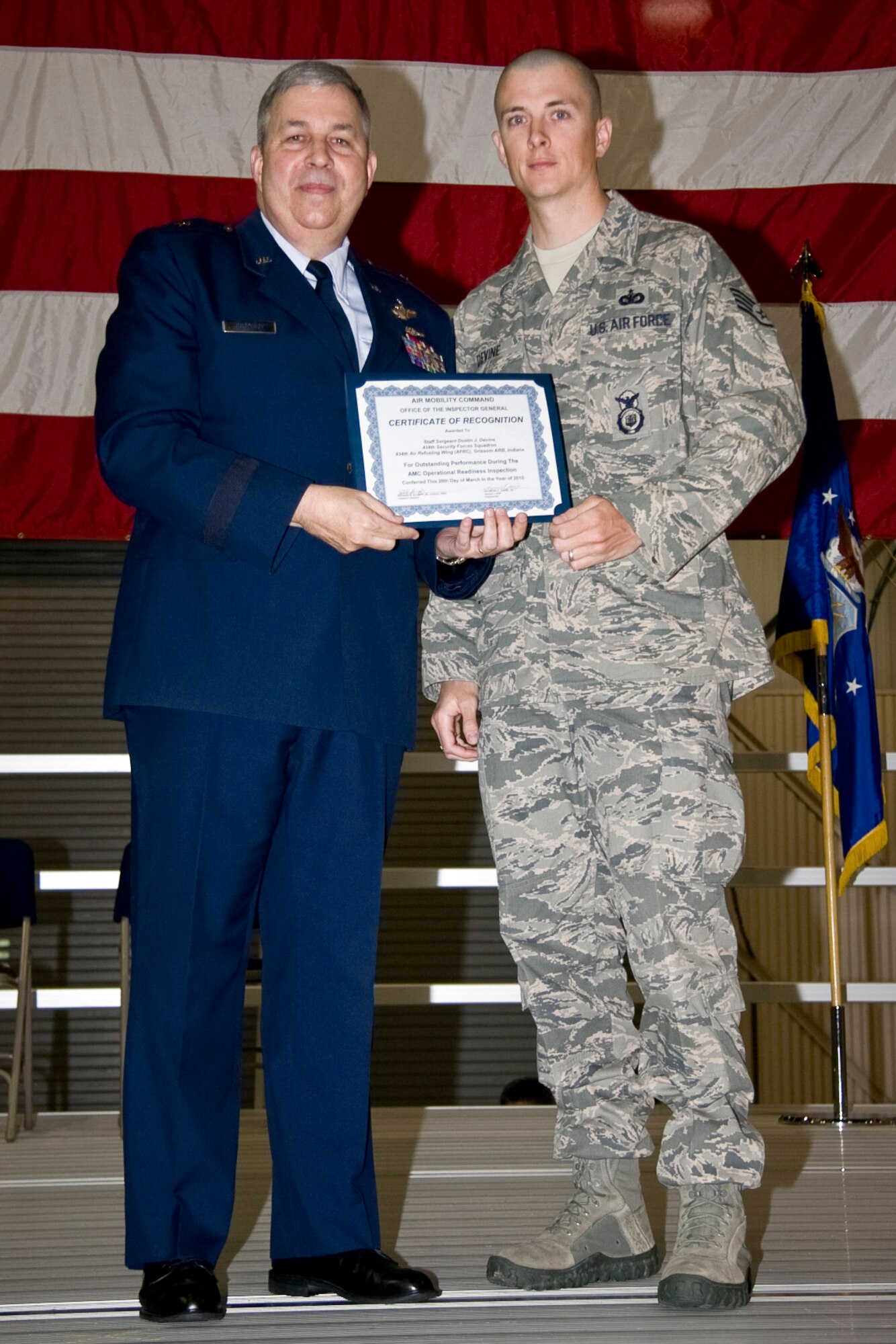 GRISSOM AIR RESERVE BASE, Ind. -- Brig. Gen. Dean Despinoy, 434th Air Refueling Wing commander, presents an Air Mobility Command certificate of recognition to Staff Sgt. Dustin Devine, 434th Security Forces Squadron. Certificates were given during a commander's call held in May to recognize outstanding performers during a recent operational readiness inspection. (U.S. Air Force photo/Tech. Sgt. Mark R. W. Orders-Woempner)
