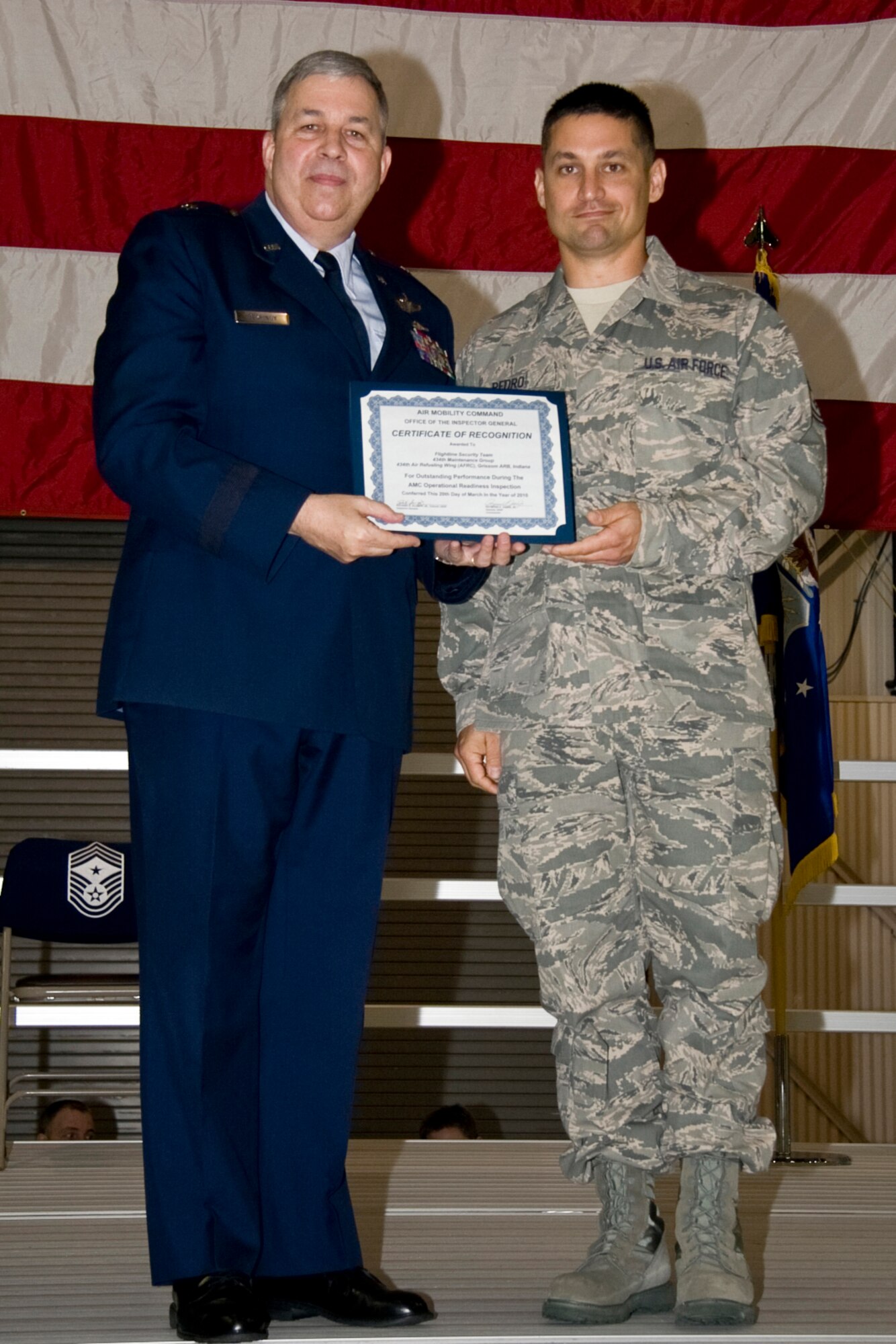 GRISSOM AIR RESERVE BASE, Ind. -- Tech. Sgt. John Pedro, II, with the 434th Maintenance Group accepts an Air Mobility Command certificate of recognition for outstanding performance with a flightline security team during a recent operational readiness inspection. The certificate was presented by Brig. Gen. Dean Despinoy, 434th Air Refueling Wing commander, during a commander's call held in May. Sergeant Pedro is a quality assurance specialist with the 434th MXG. (U.S. Air Force photo/Tech. Sgt. Mark R. W. Orders-Woempner)