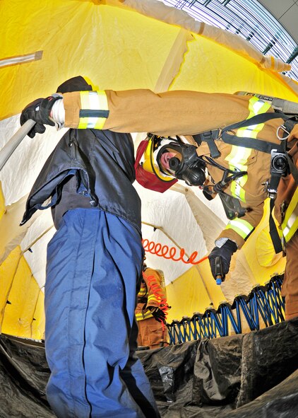 The Niagara Falls Air Reserve Station Fire Department lends support during a simulated chemical spill exercise at the Rainbow Bridge, May 12, 2010, Niagara Falls, NY. The Rainbow Bridge was closed to international travel during the multi agency drill where members of the Niagara Falls Air Reserve Station Fire Department set up a mobile decontamination facility. (U.S. Air Force photo by Staff Sgt. Joseph McKee)