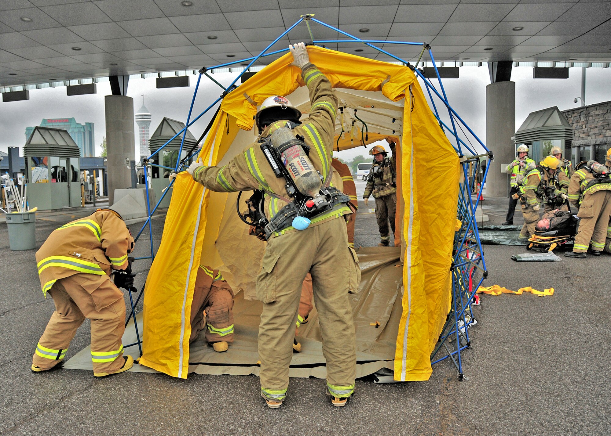 The Niagara Falls Air Reserve Station Fire Department lends support during a simulated chemical spill exercise at the Rainbow Bridge, May 12, 2010, Niagara Falls, NY. The Rainbow Bridge was closed to international travel during the multi agency drill where members of the Niagara Falls Air Reserve Station Fire Department set up a mobile decontamination facility. (U.S. Air Force photo by Staff Sgt. Joseph McKee)