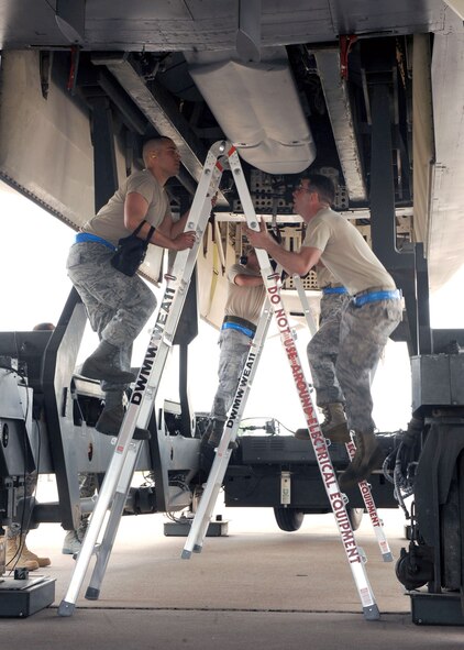 DYESS AIR FORCE BASE, Texas – Airman 1st Class Jason Jaramillo (left) and Senior Airman Michael Pier, both from the 7th Aircraft Maintenance Squadron, mate missiles to the B-1 Bomber May 12 here. The 7th Bomb Wing is one of seven bomb wings to participate in Air Force Global Strike Command’s first load competition. The competition consists of a uniform inspection, general knowledge test, tool inspection, munitions build, weapons load and B-1 Bomber pre-flight inspection. (U.S. Air Force photo/ Airman 1st Class Chelsea Browning) 