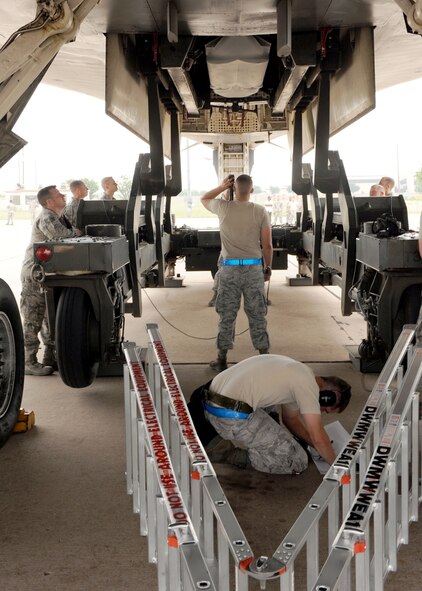 DYESS AIR FORCE BASE, Texas - 7th Aircraft Maintenance Squadron Airmen check clearances May 12 here they load missiles while Global Strike Challenge inspectors observe. The 7th Bomb Wing is one of seven bomb wings to participate in Air Force Global Strike Command’s first load competition. The competition consists of a uniform inspection, general knowledge test, tool inspection, munitions build, weapons load and B-1 Bomber pre-flight inspection. (U.S. Air Force photo/ Airman 1st Class Chelsea Browning)