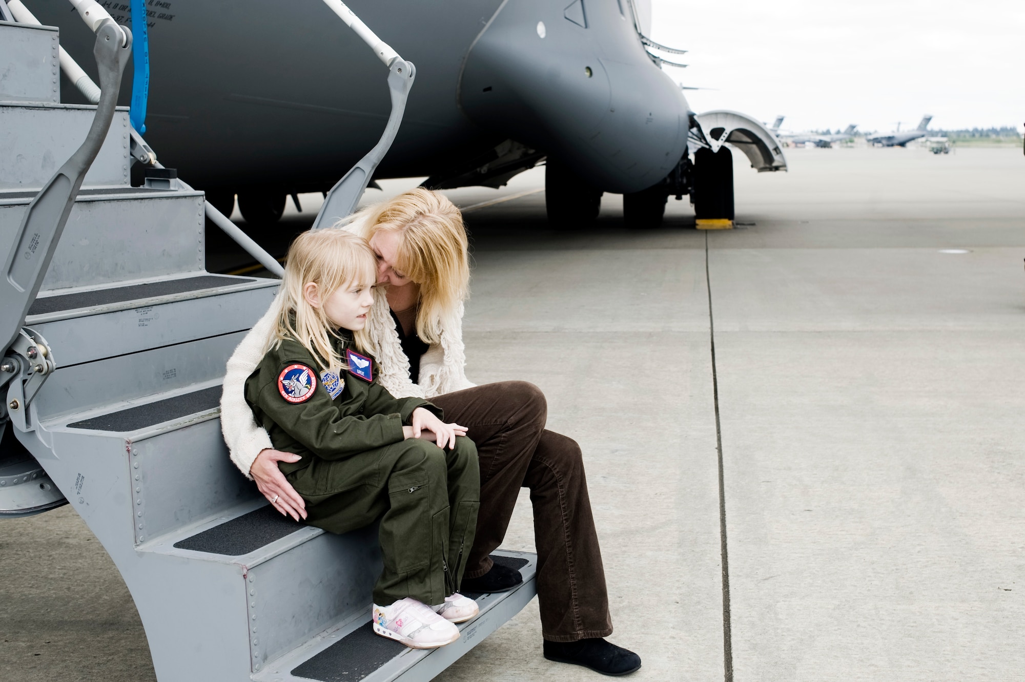 Kaylie Bergen, age 6, and her mother Christy share a moment on the steps of a C-17 Globemaster III following a tour of the aircraft May 11. (U.S. Air Force Photo by Abner Guzman)


