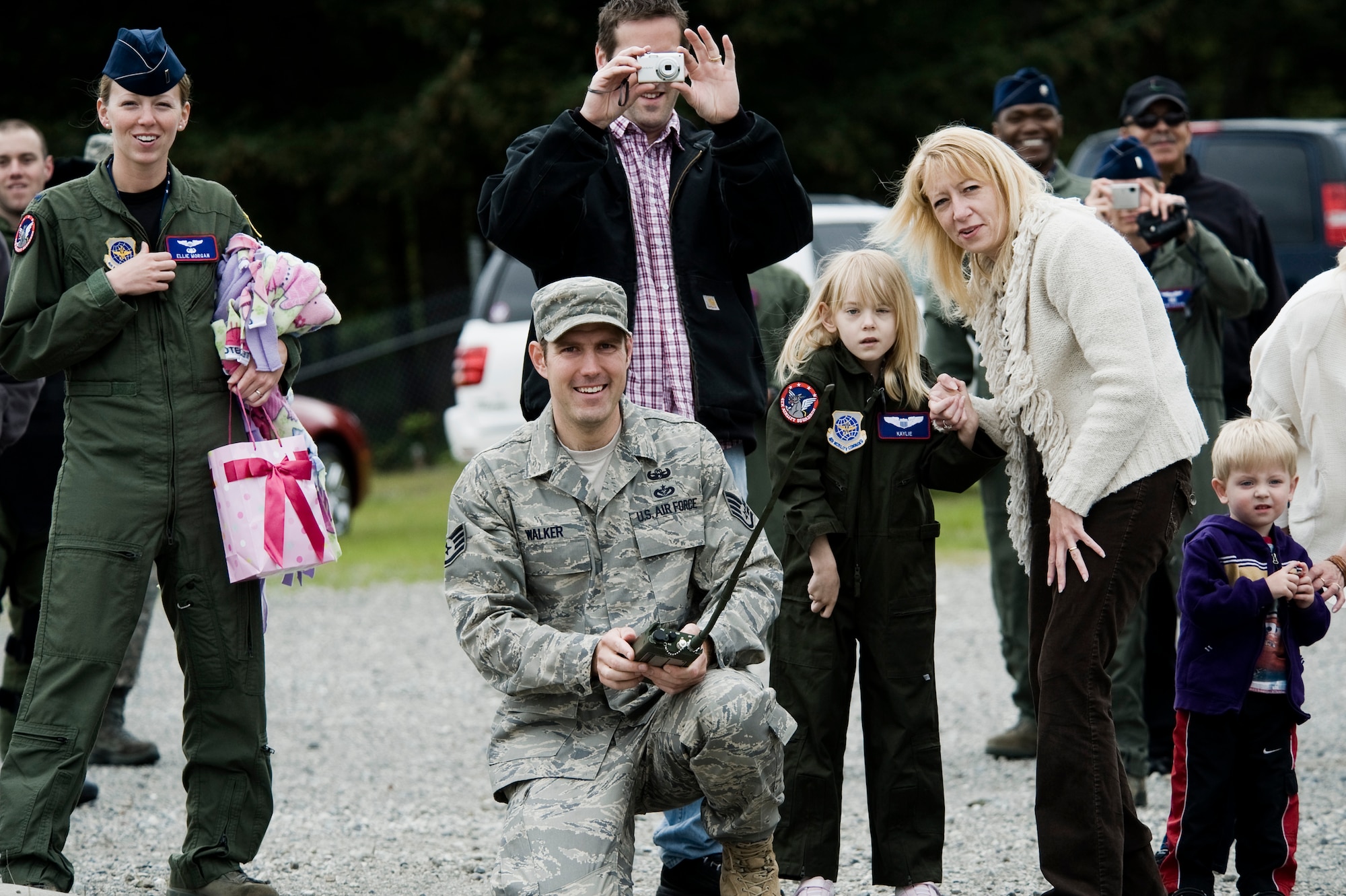 Pilot for a Day candidate Kaylie Bergen, age 6, and her family look on as Staff Sgt. Mark Walker, 62nd Civil Engineer Squadron, detonates an explosive as part of an EOD demonstration May 11. (U.S. Air Force Photo by Abner Guzman)

