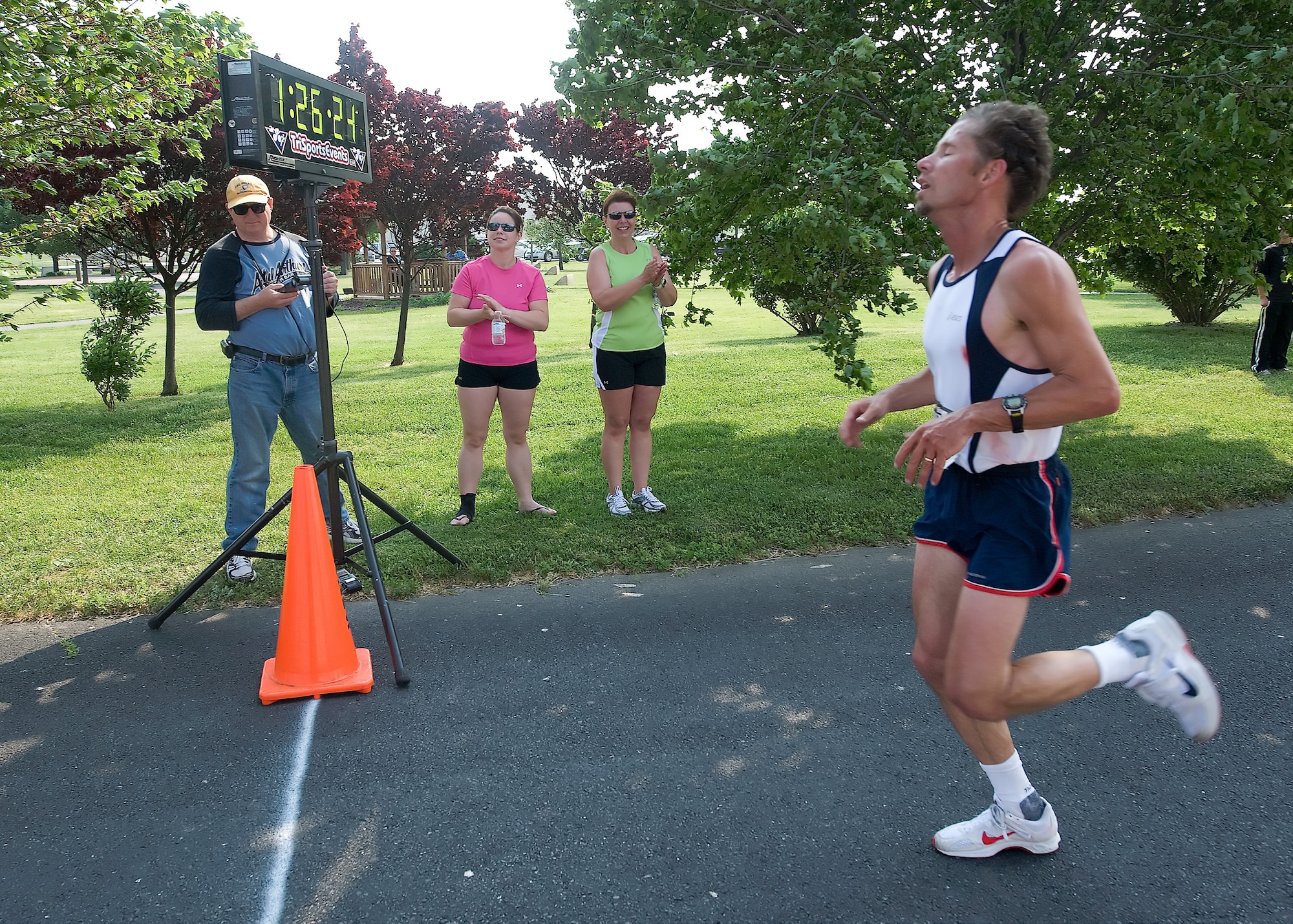 Michael Sewell of Smyrna, Del., crosses the finish line to secure first place during the Dover Air Force Base Heritage Half Marathon May 8. Awards were given to the top placers, and all participants received  an Air Mobility Command Museum token. (U.S. Air Force photo/Brianne Zimny)