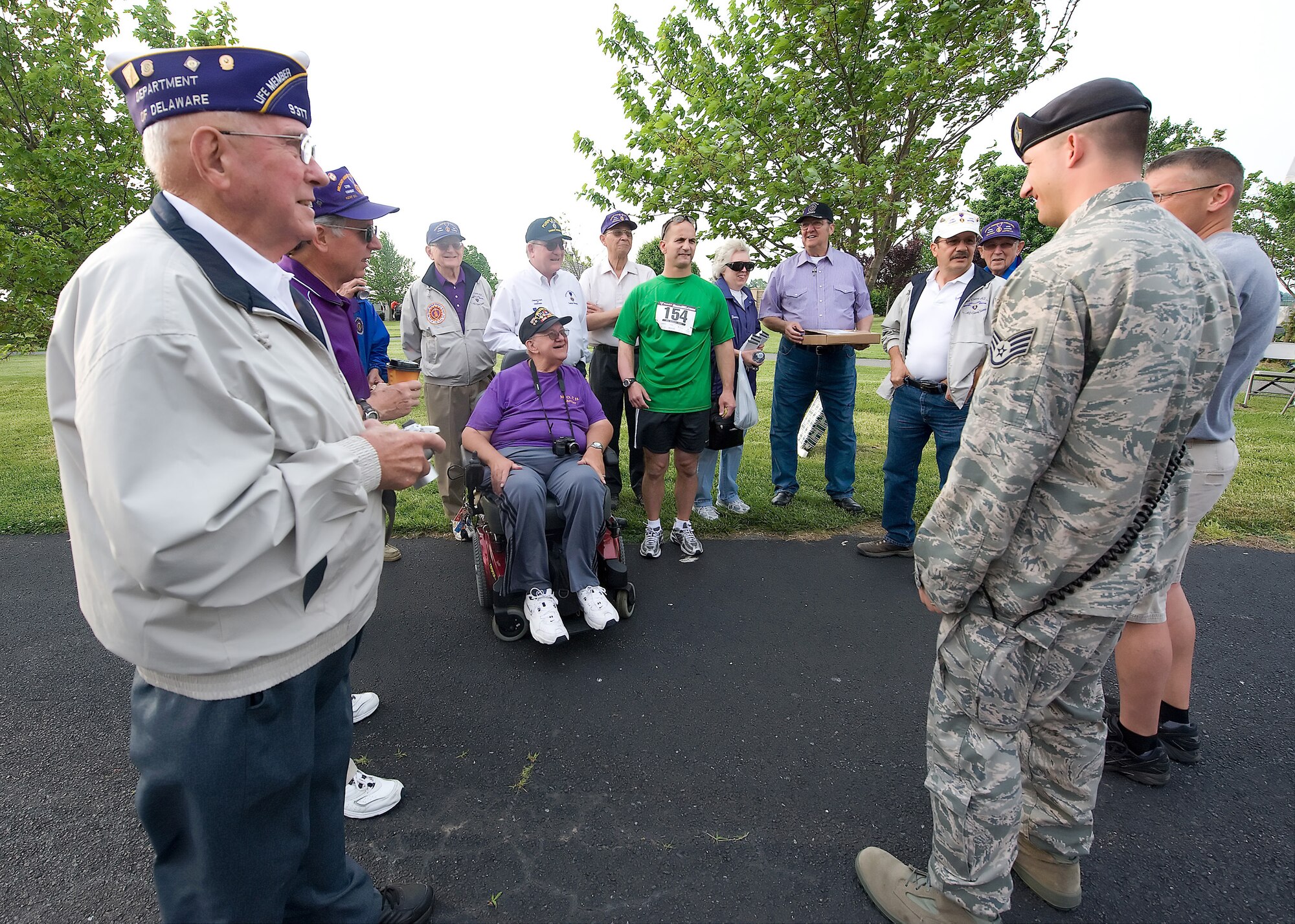 The Military Order of the Purple Heart of Delaware, runners and servicemembers talk during the Dover Air Force Base Heritage Half Marathon May 8. The Heritage Half Marathon is the first Marathon hosted by Dover AFB,  there was also a 5K and Kiddie 1K run. (U.S. Air Force photo/Brianne Zimny) 