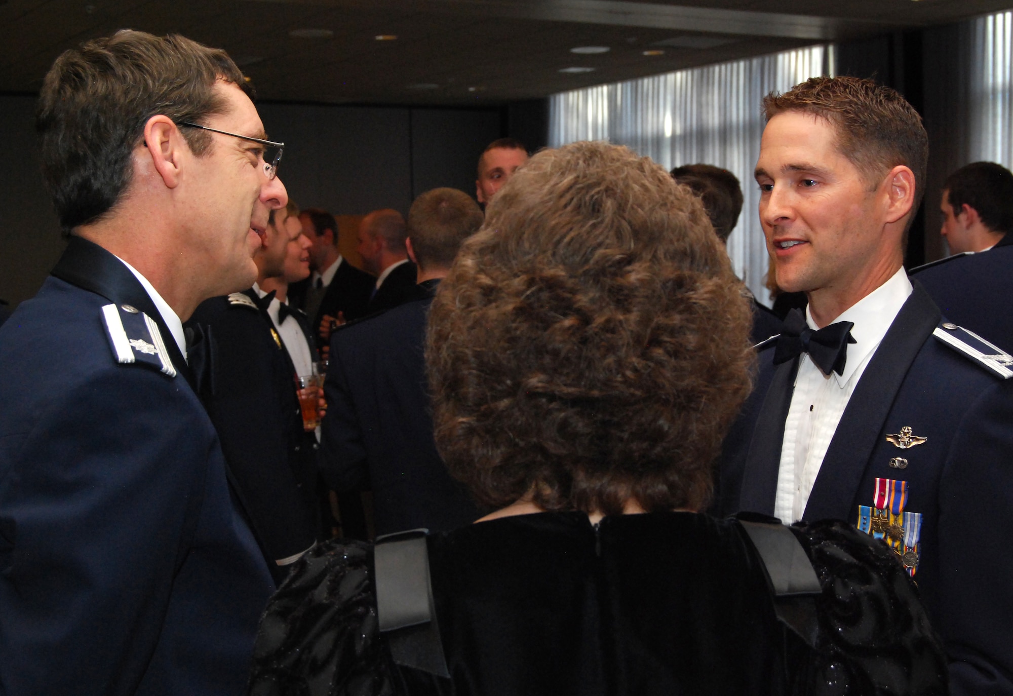 Dr. Gary Yale and his wife, Debbie, talk to Col. Jim Dutton during social hour at a Department of Astronautics dining-out in the Air Force Academy's Falcon Club May 7, 2010. Colonel Dutton, a 1991 Academy graduate, was Space Shuttle Discovery's pilot for the STS-131 mission to the International Space Station in April. Dr. Yale is an assistant professor with the Academy's Department of Systems Engineering. (U.S. Air Force photo/Staff Sgt. Don Branum)