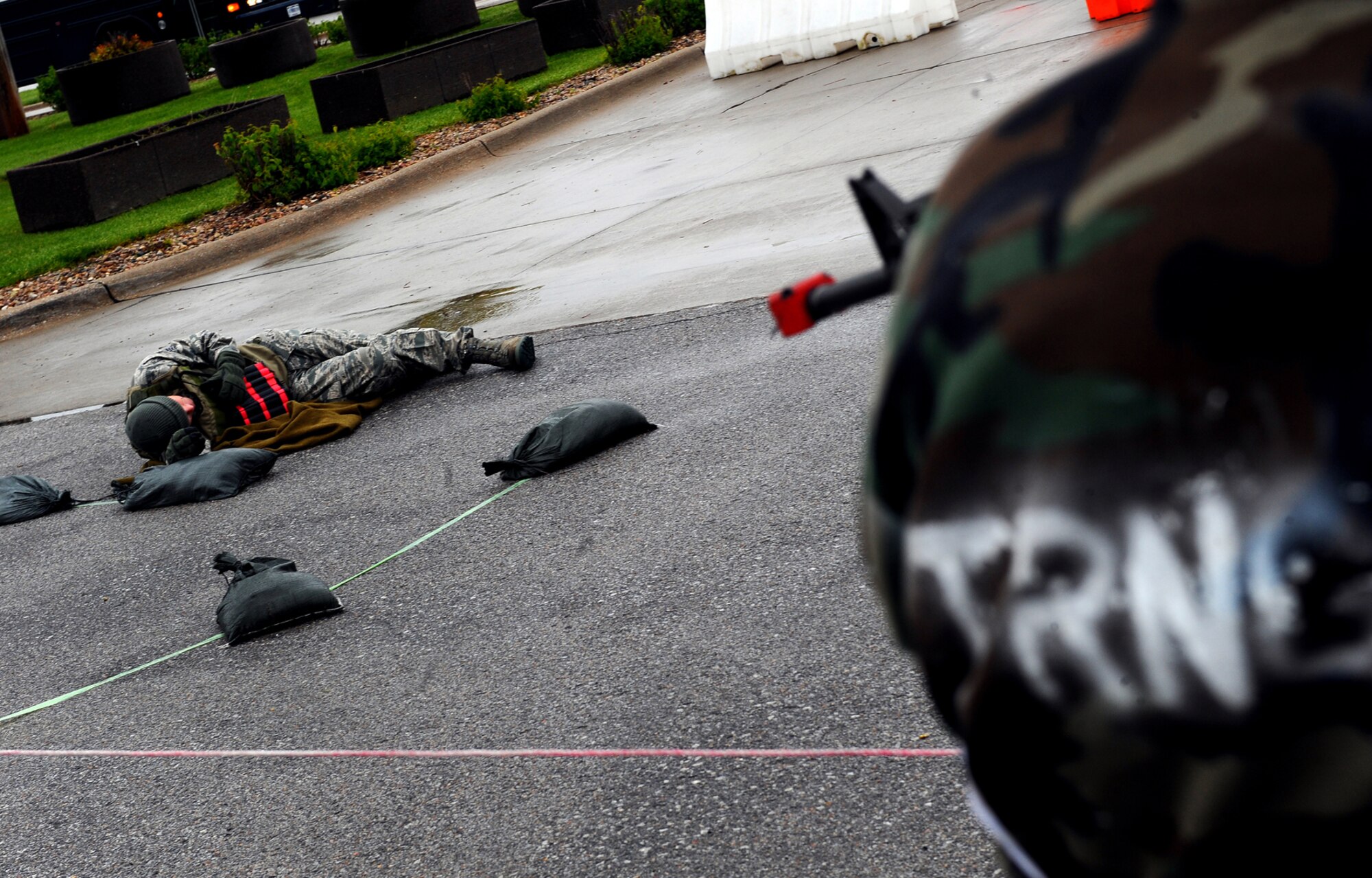 OFFUTT AIR FORCE BASE, Neb, -- A mock suicide bomber lays at the foot of the Base "X," gates (a simulated base used to simulate a deployed location) after a simulated attack that consisted of a chemical attack and numerous gunmen here May 13. Members of Team Offutt are undergoing extensive training as part of an Operational Readiness Exercise designed to keep Airmen ready to accomplish the mission at deployed locations throughout the world. U.S. Air Force Photo by Josh Plueger
