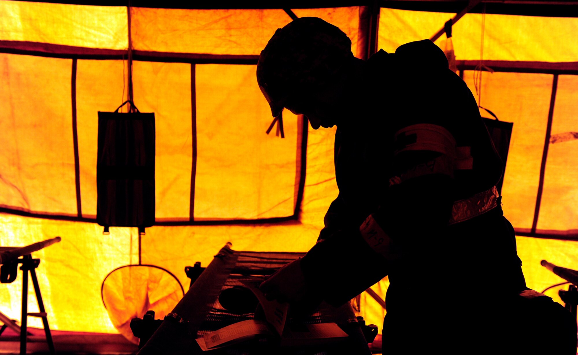 OFFUTT AIR FORCE BASE, Neb. -- Tech. Sgt. Tim Nelson, 55th Medical Group, reviews his Airman's Manual following an attack at the Base "X," gates (a simulated base used to simulate a deployed location) that consisted of a chemical attack, suicide bomber and numerous gunmen here May 13.  Members of Team Offutt are undergoing extensive training as part of an Operational Readiness Exercise designed to keep Airmen ready to accomplish the mission at deployed locations throughout the world. U.S. Air Force Photo by Josh Plueger
